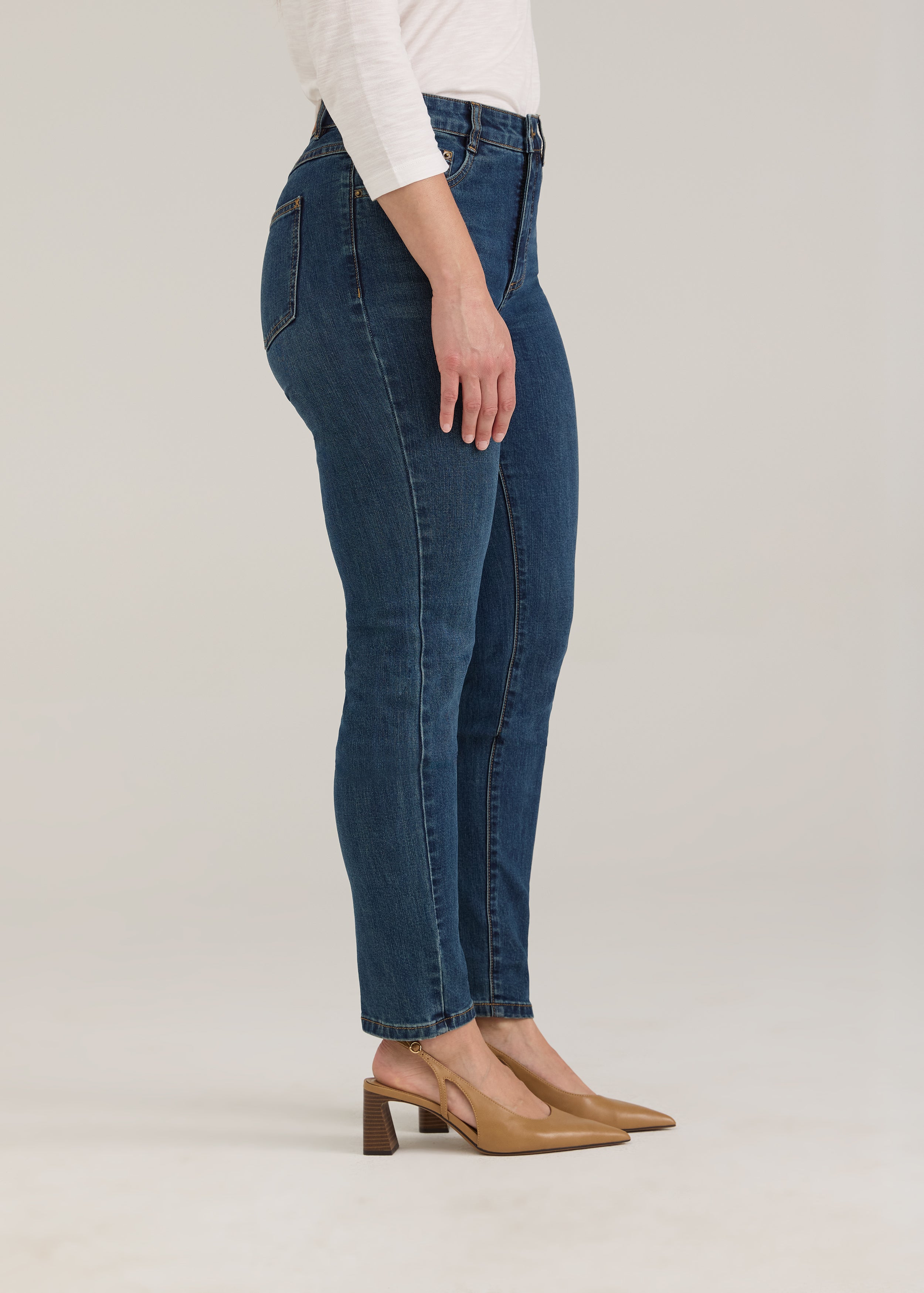Side profile of dark wash slim leg jeans highlighting the silhouette by French Dressing Jeans (FDJ)