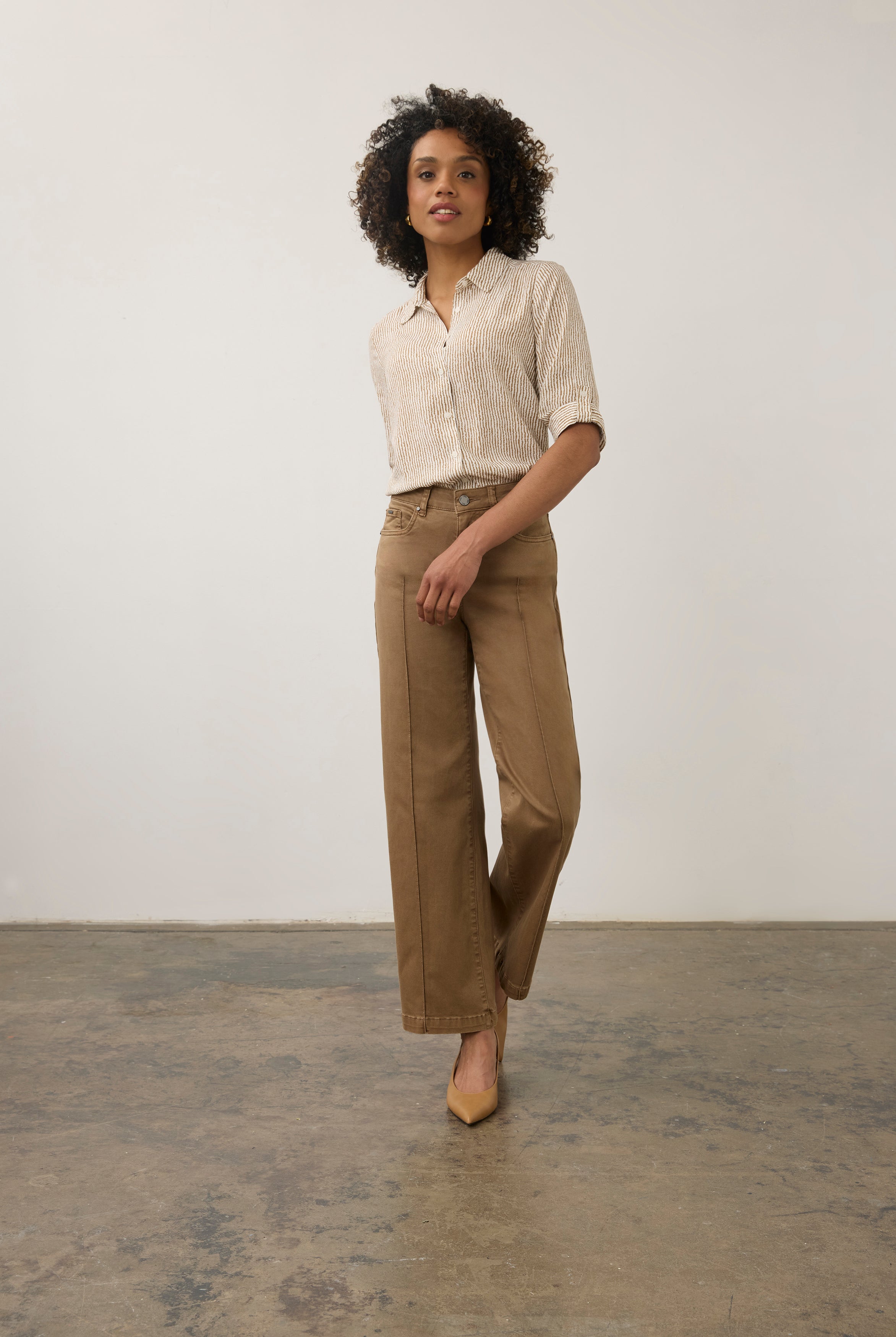 Model in striped beige and white shirt and khaki pants, full body view by French Dressing Jeans (FDJ)