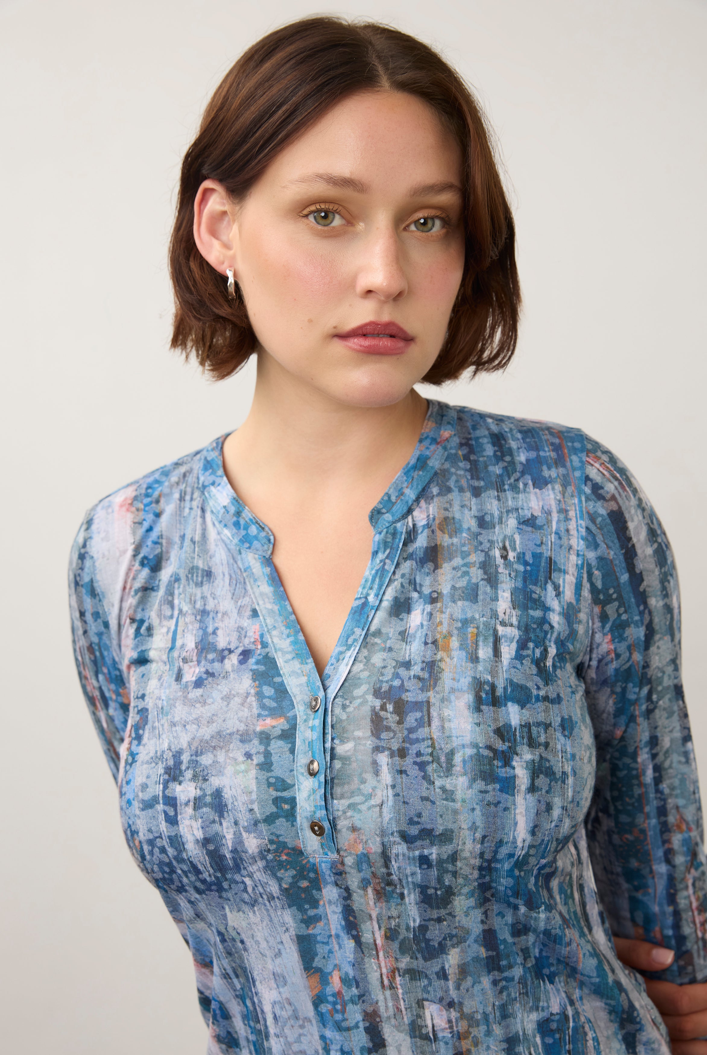 Close-up of button and neckline detail on blue patterned 3/4 sleeve top by French Dressing Jeans (FDJ)