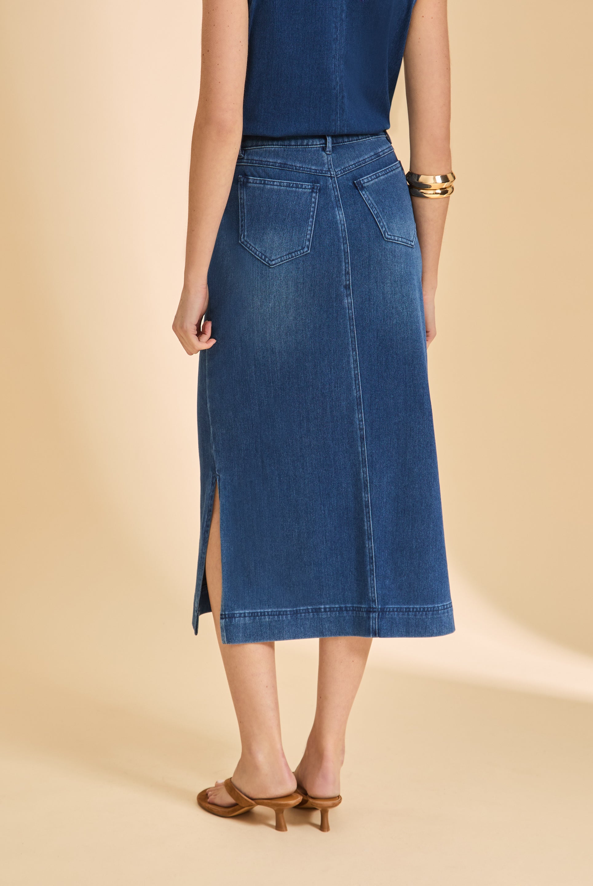 Back view of blue denim skirt featuring patch pockets and slit by French Dressing Jeans (FDJ)