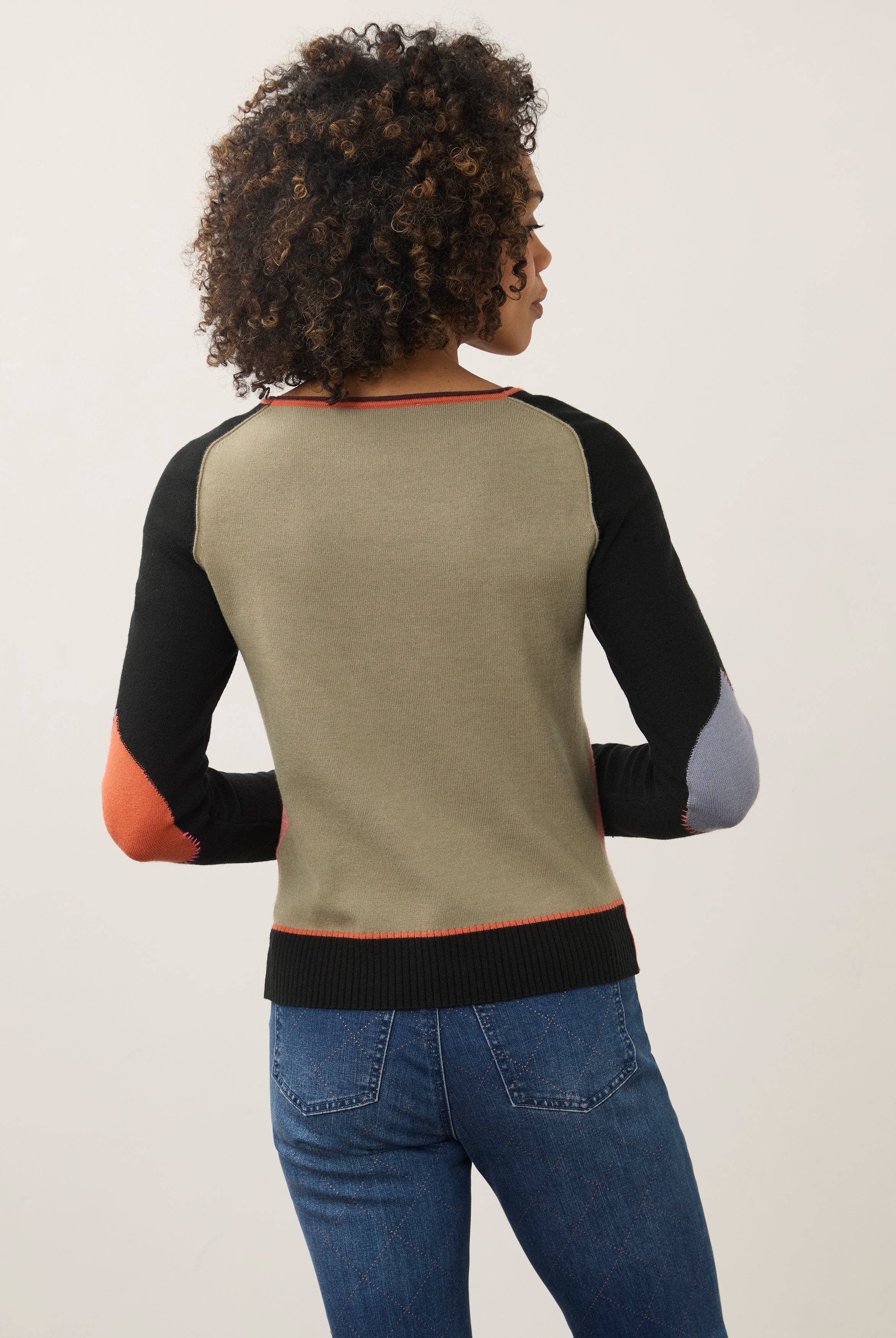 Back view of pink and black colorblock sweater showing seamless design by French Dressing Jeans (FDJ)