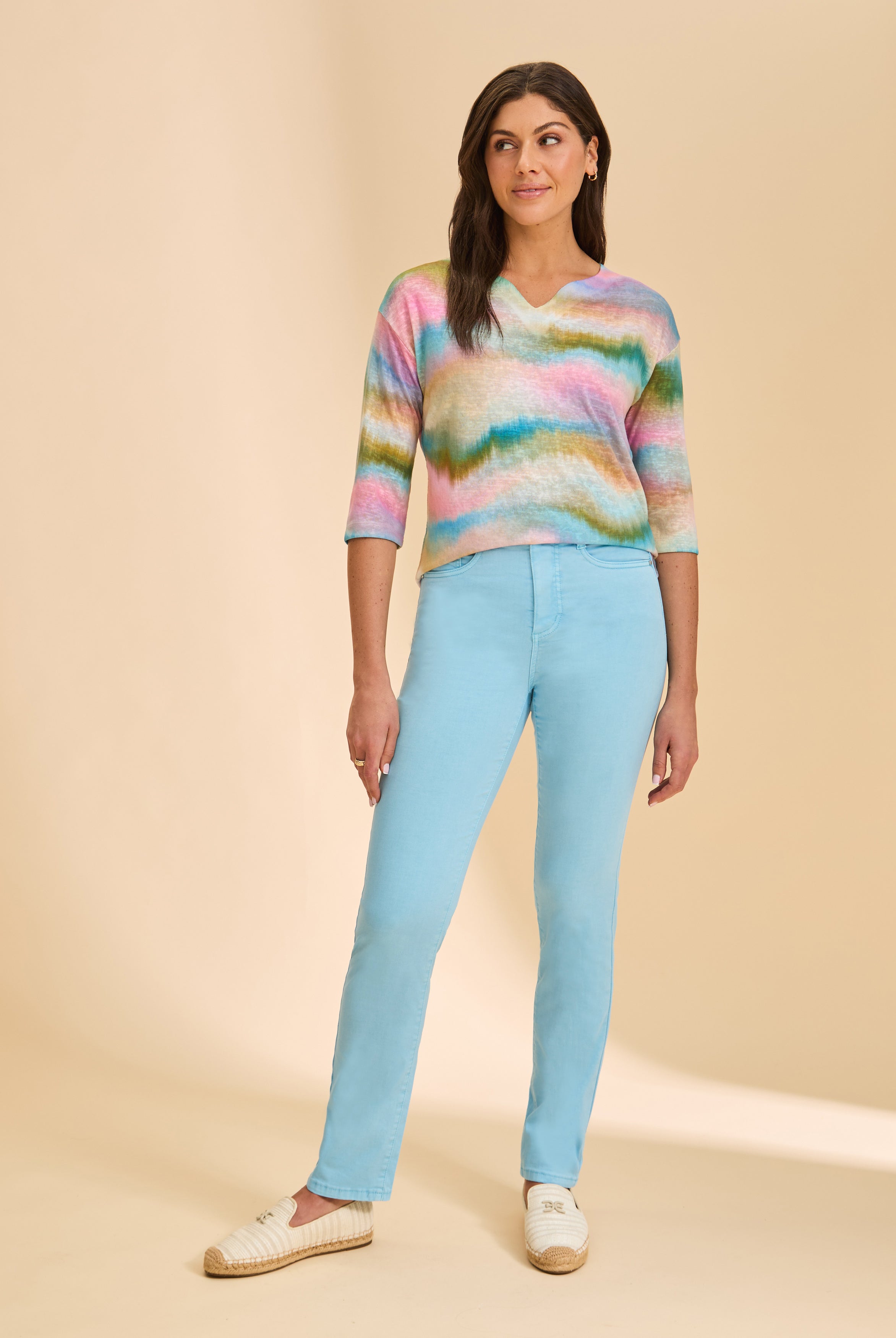 Front view of light blue straight-leg jeans, paired with colorful top by French Dressing Jeans (FDJ)