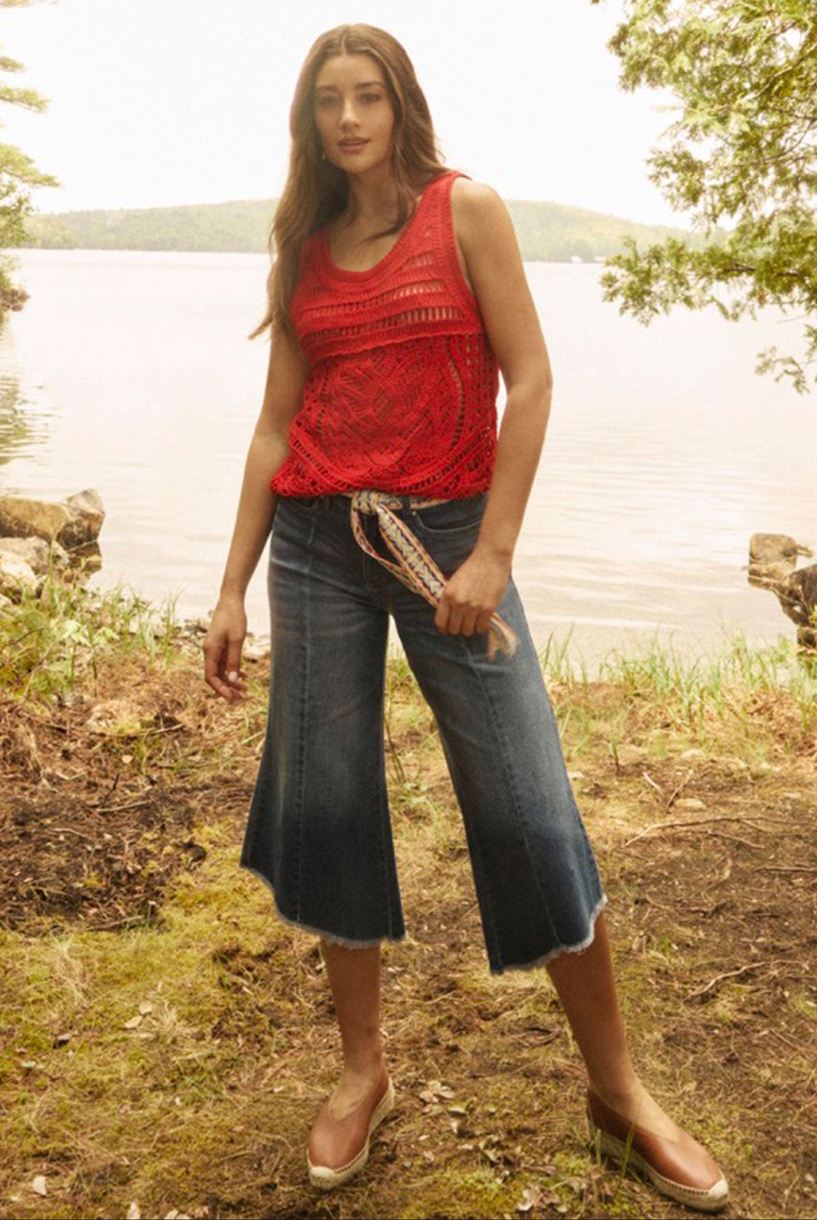 Woman in red crochet tank top by a lakeside setting by French Dressing Jeans (FDJ)
