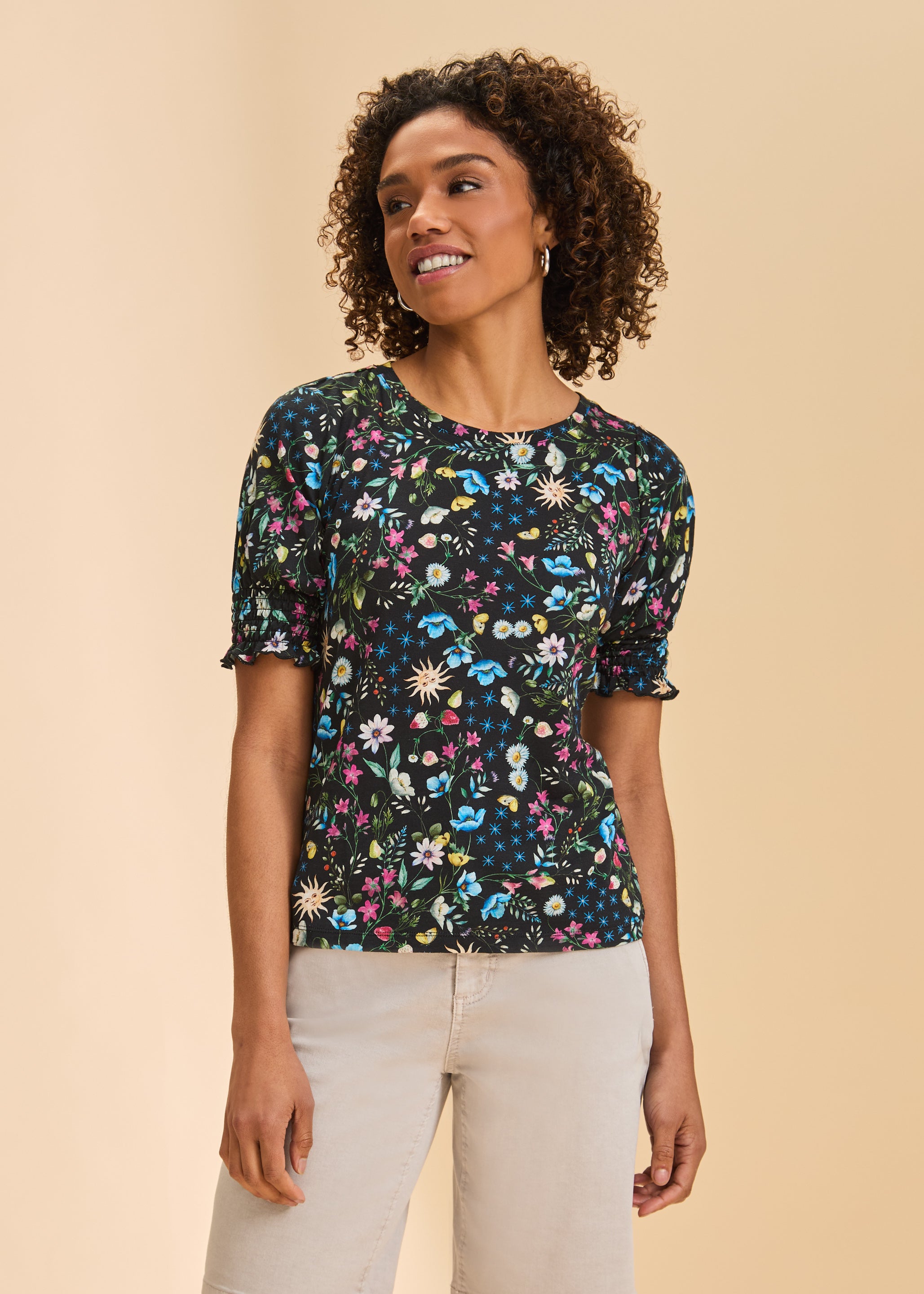 Front view of black floral short sleeve top with smocked sleeves and round neckline by French Dressing Jeans (FDJ)