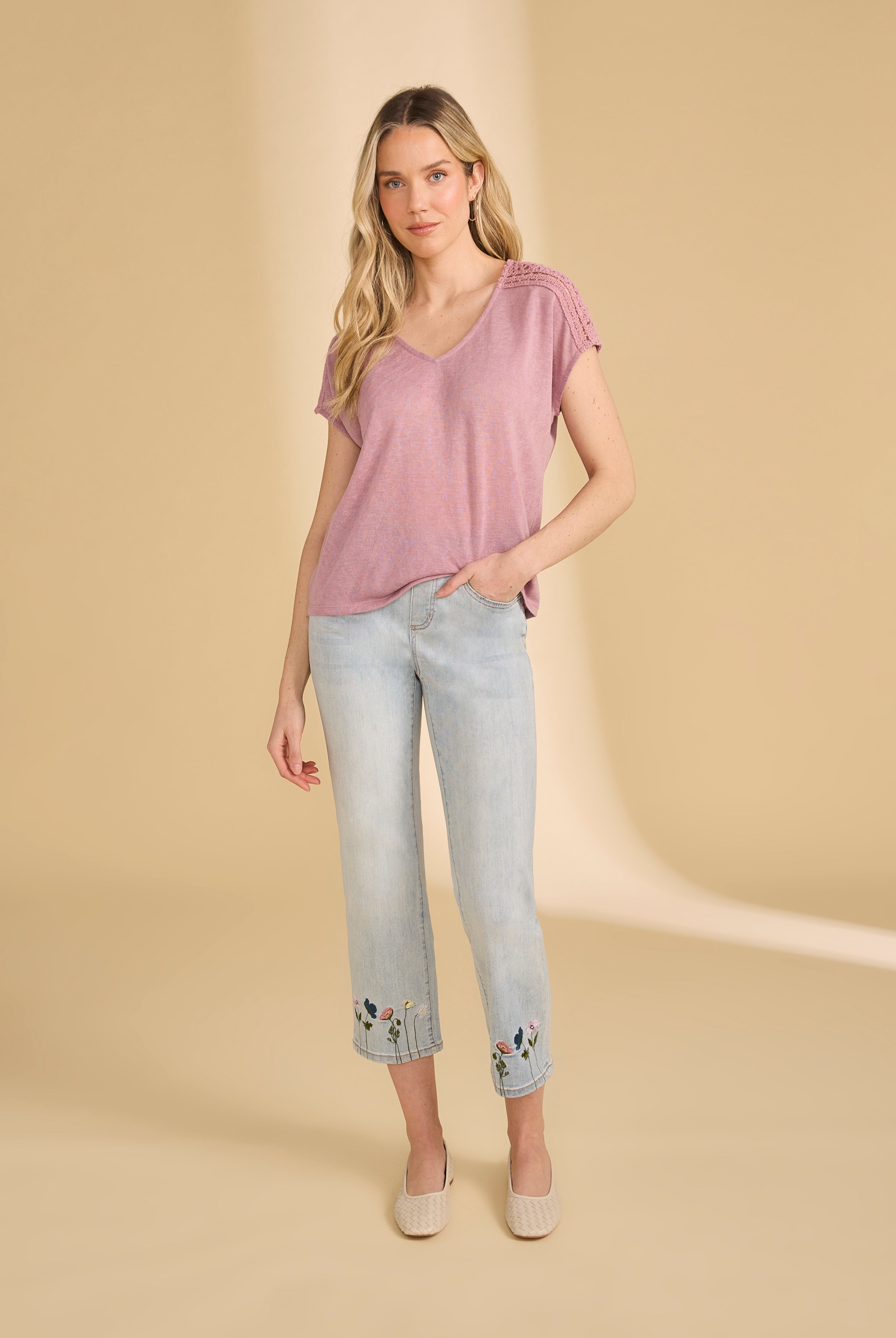 Full view of pink V-neck top paired with embroidered jeans and flats by French Dressing Jeans (FDJ)