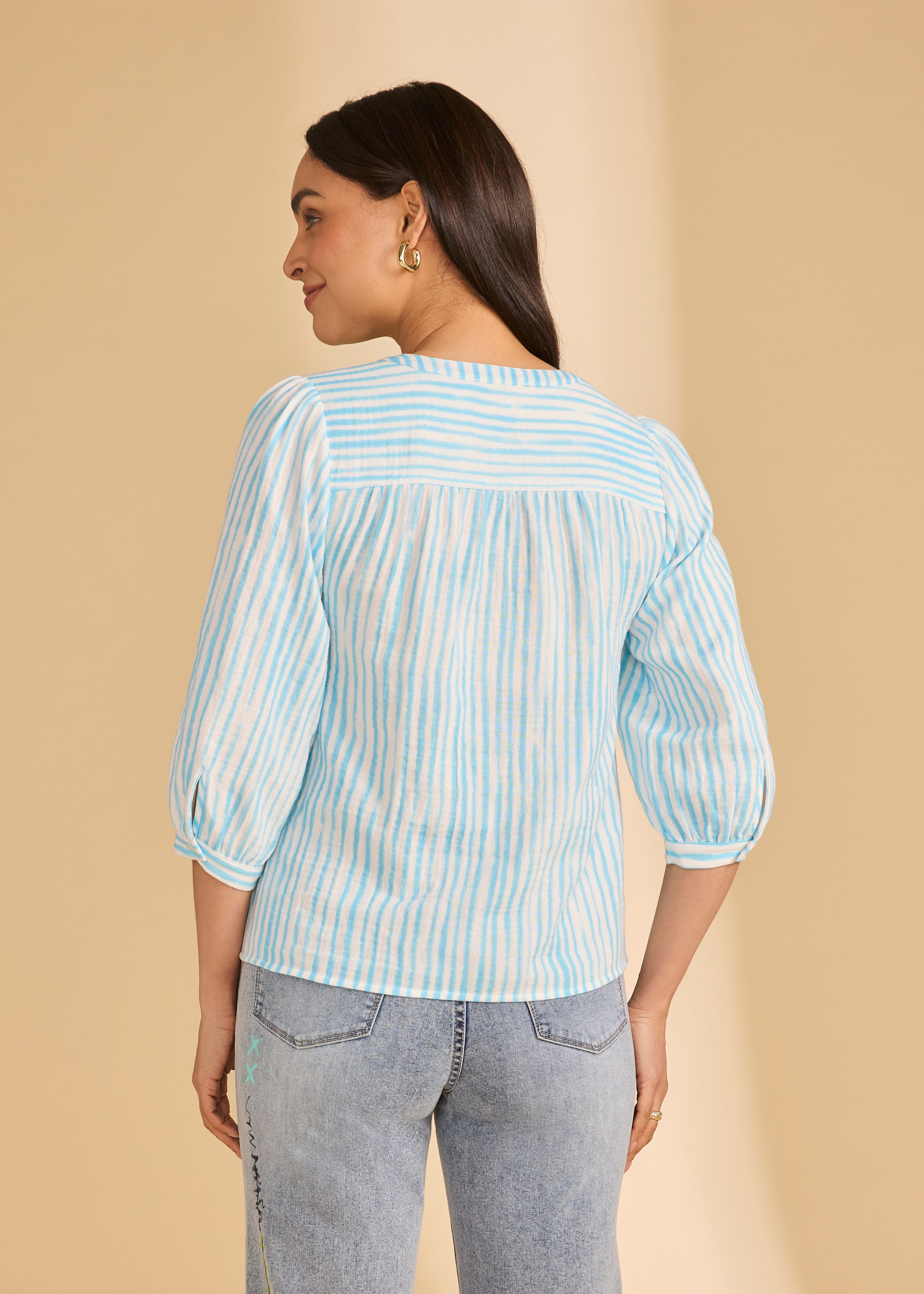 Back view of light blue striped blouse showing yoke and soft pleats by French Dressing Jeans (FDJ)