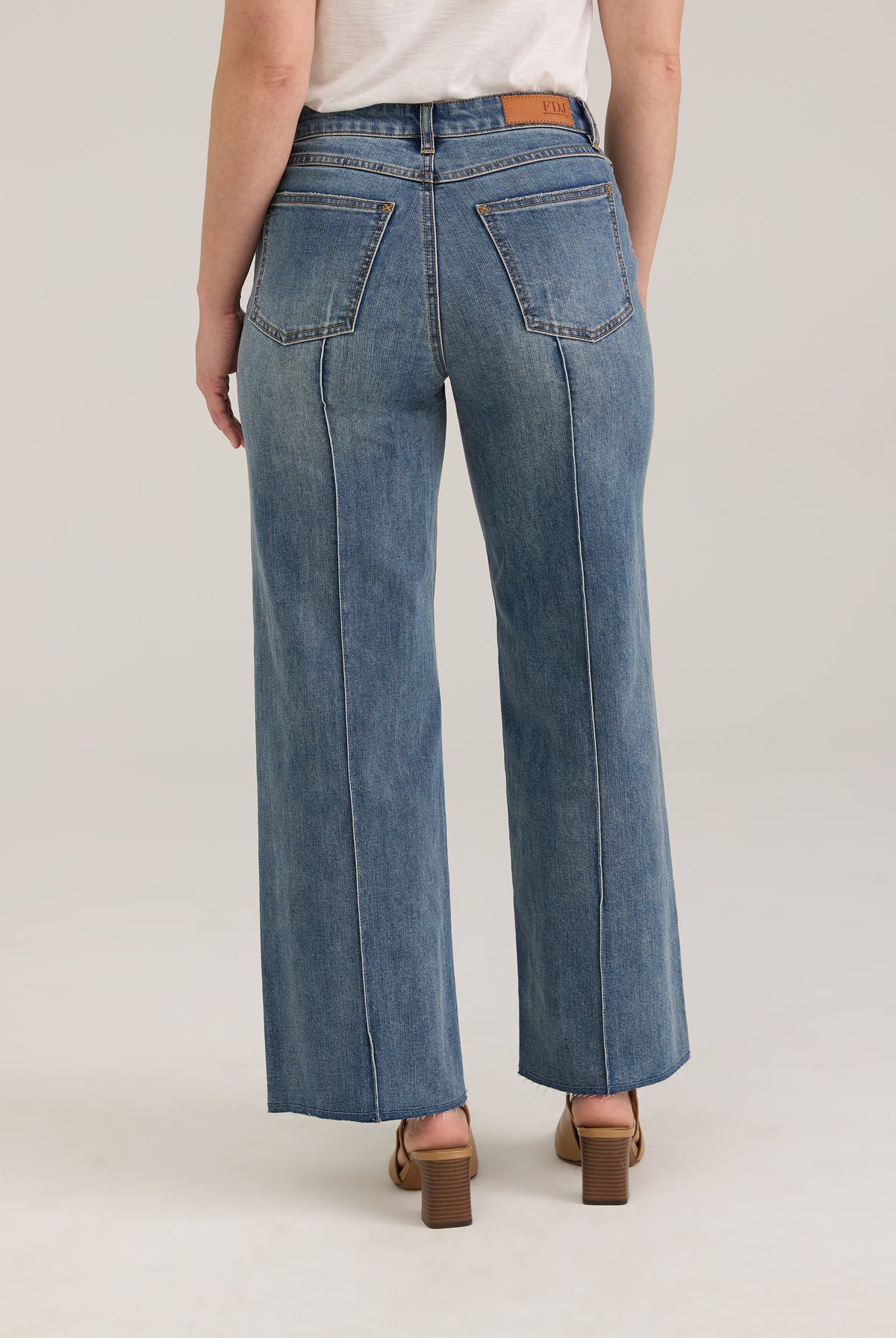 Back view of Olivia wide ankle jeans in light wash featuring back pockets and mid-rise design by French Dressing Jeans (FDJ)