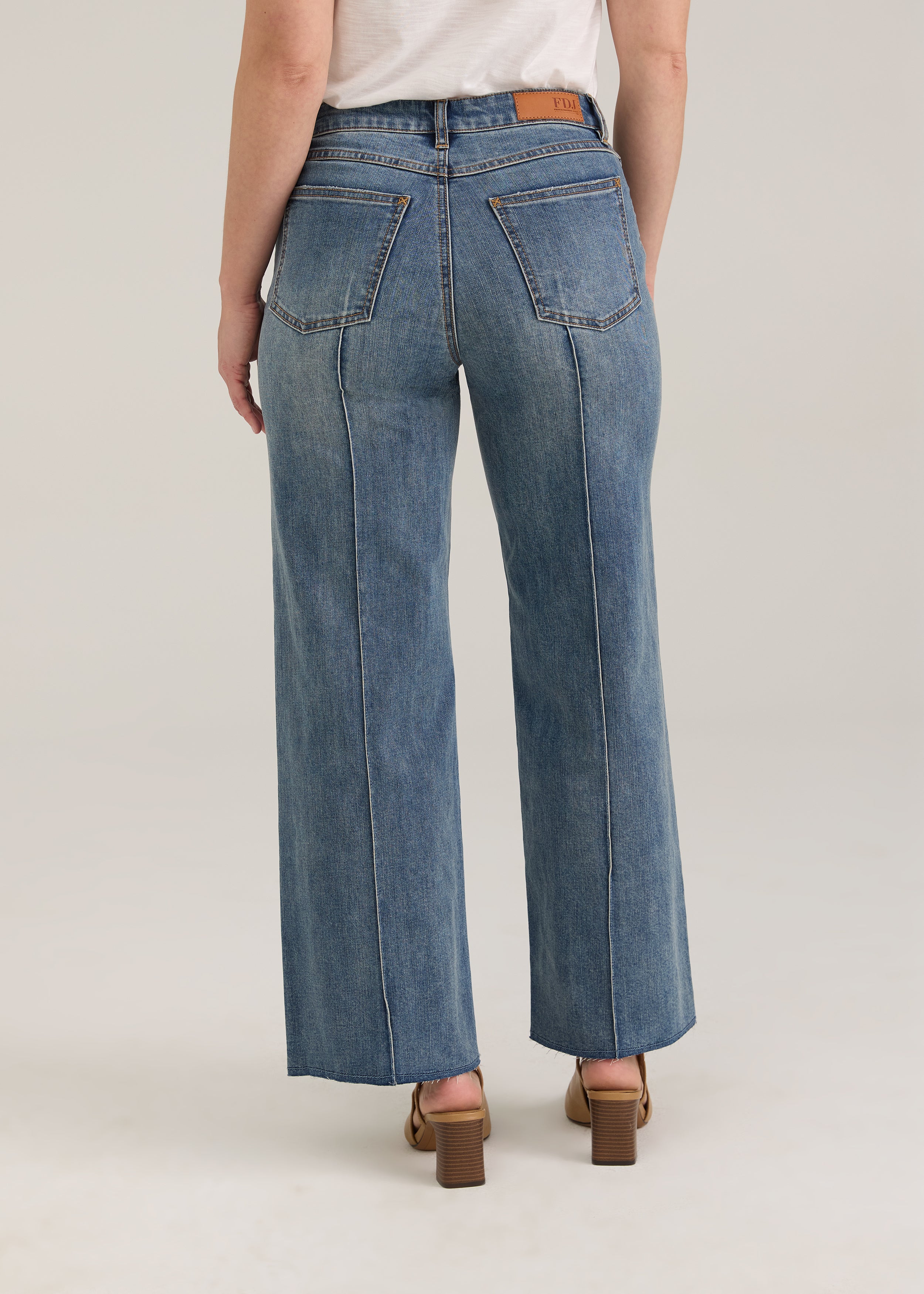 Back view of Olivia wide ankle jeans in light wash featuring back pockets and mid-rise design by French Dressing Jeans (FDJ)
