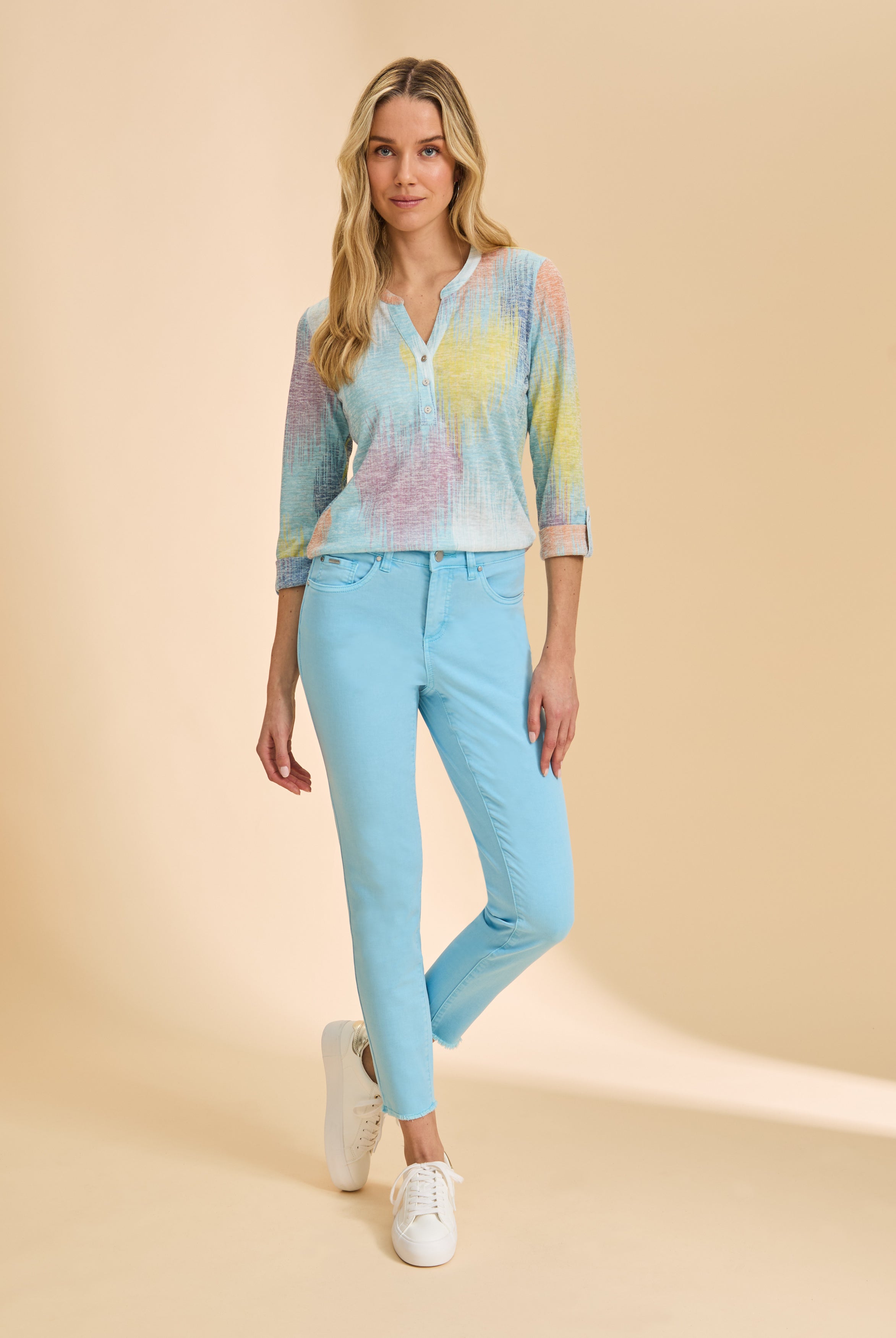 Full view of pastel patterned top paired with blue pants by French Dressing Jeans (FDJ)