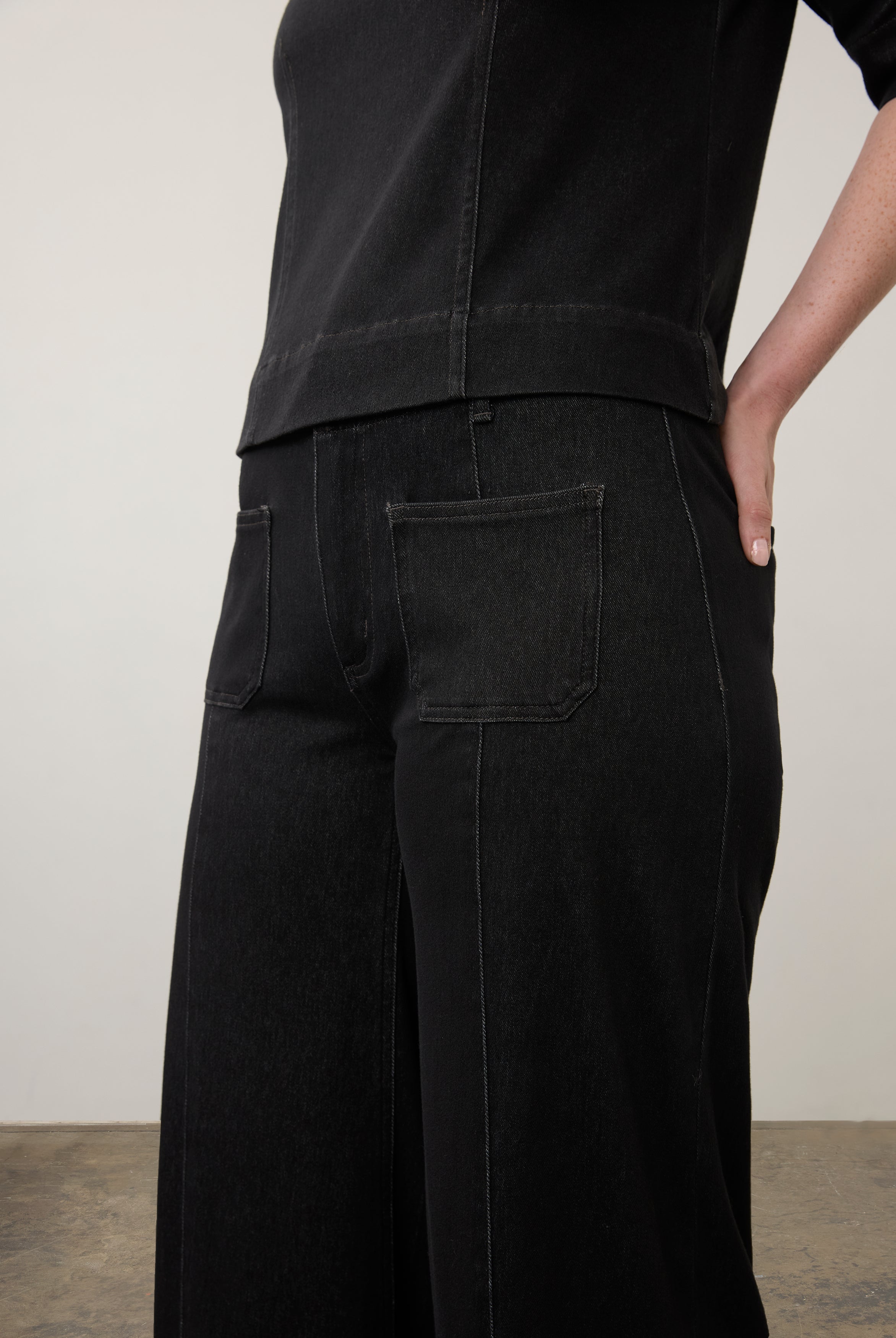 Side detail of black wide-leg jeans focusing on pocket design and stitching by French Dressing Jeans (FDJ)