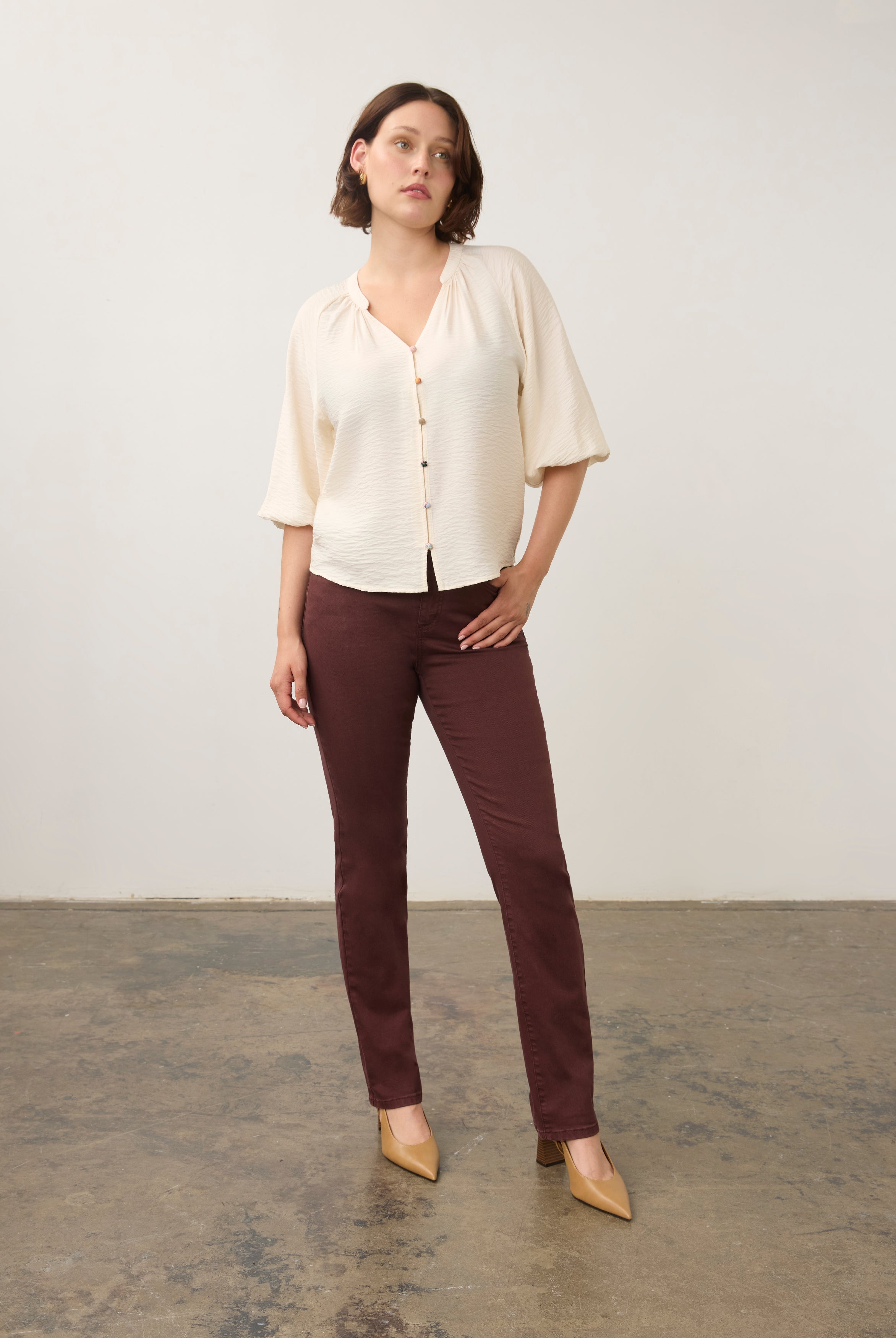 Model in cream blouse and maroon pants, full body view by French Dressing Jeans (FDJ)