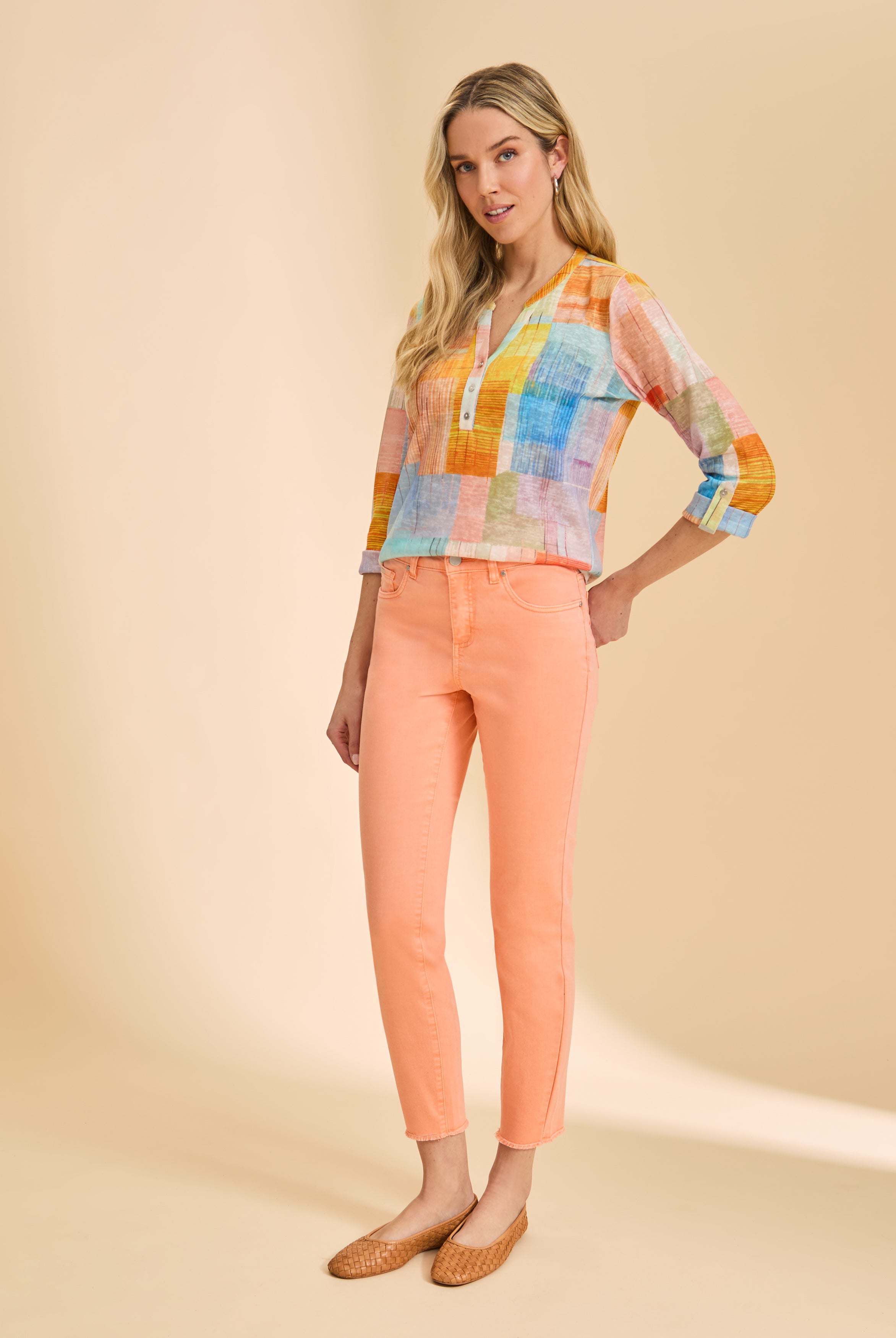 Full-length view of pastel patchwork top with orange jeans by French Dressing Jeans (FDJ)