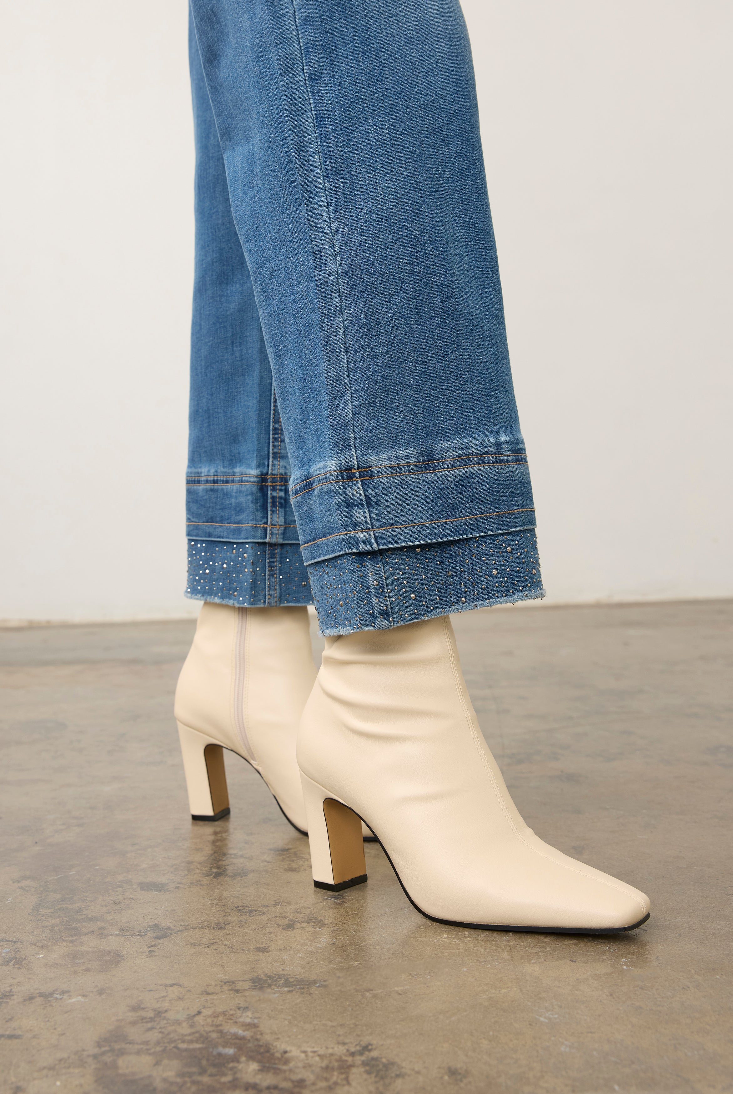 Close-up of medium blue denim showcasing wide ankle hem detail by French Dressing Jeans (FDJ) par French Dressing Jeans (FDJ)