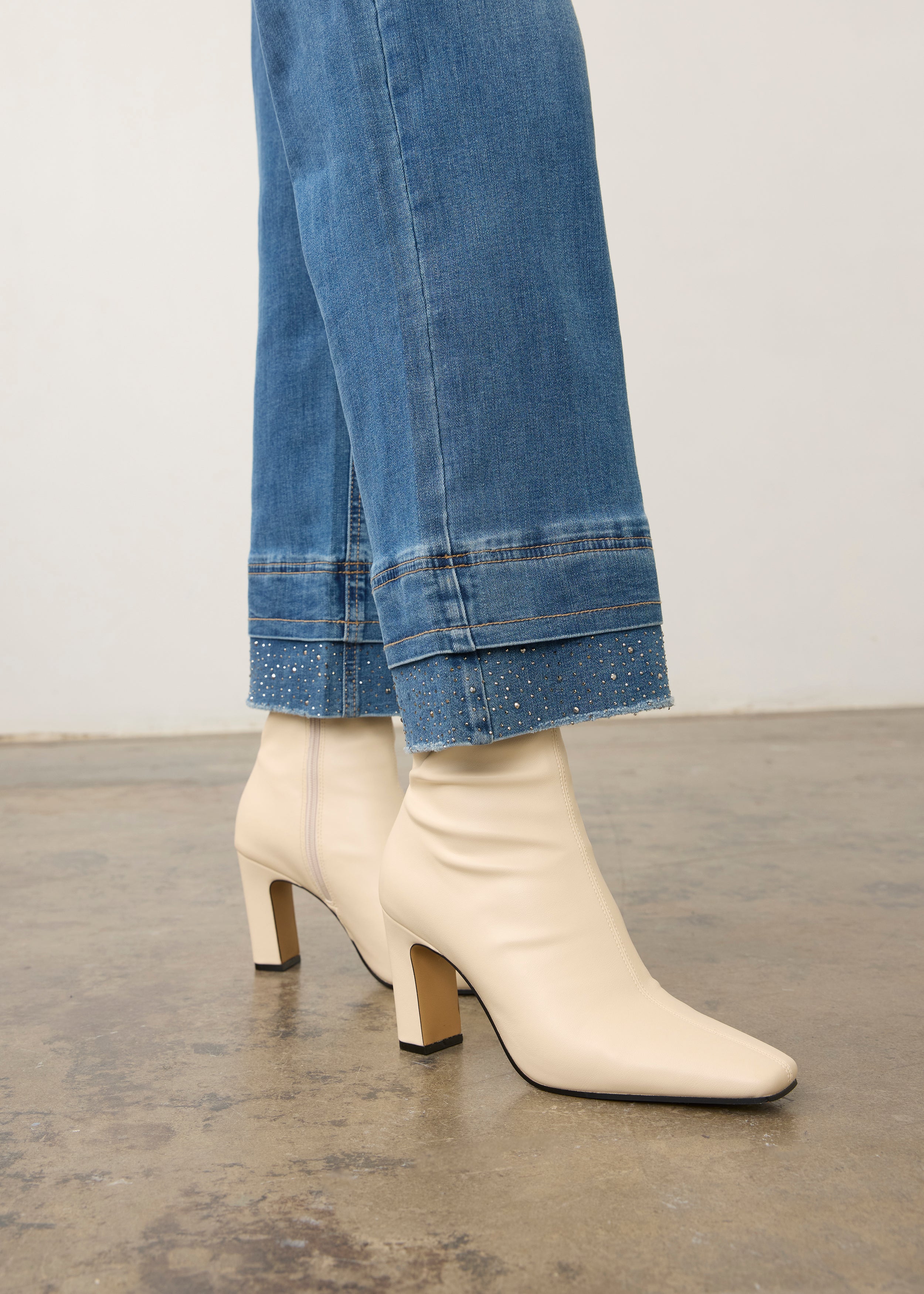 Close-up of medium blue denim showcasing wide ankle hem detail by French Dressing Jeans (FDJ) par French Dressing Jeans (FDJ)
