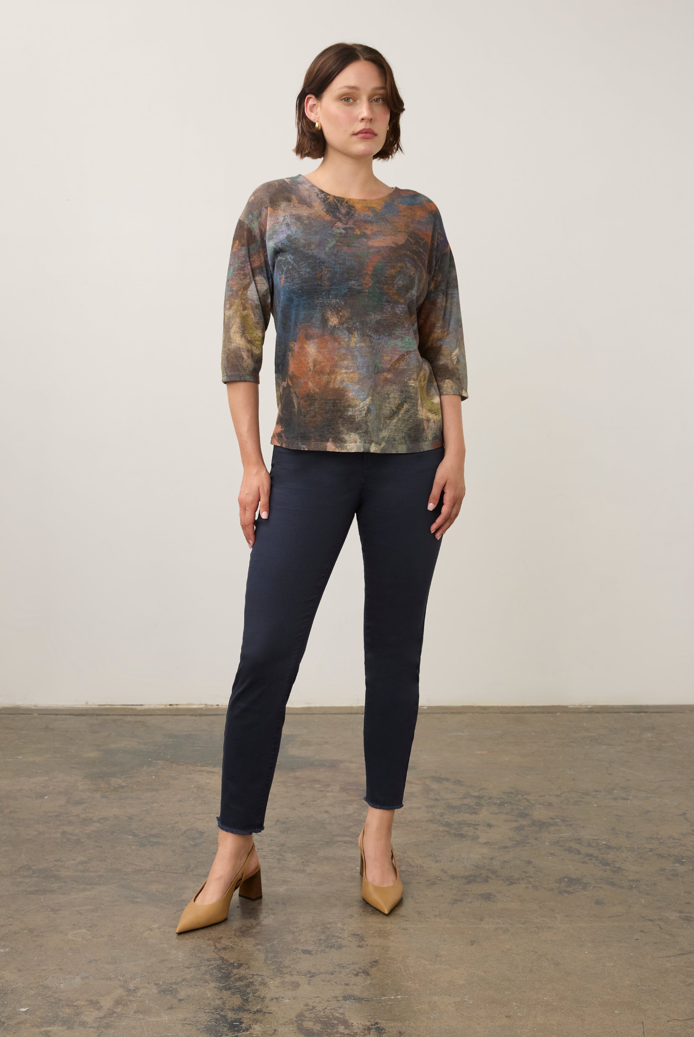 Full body view of earthy-toned Henley top styled with navy pants and heels by French Dressing Jeans (FDJ)