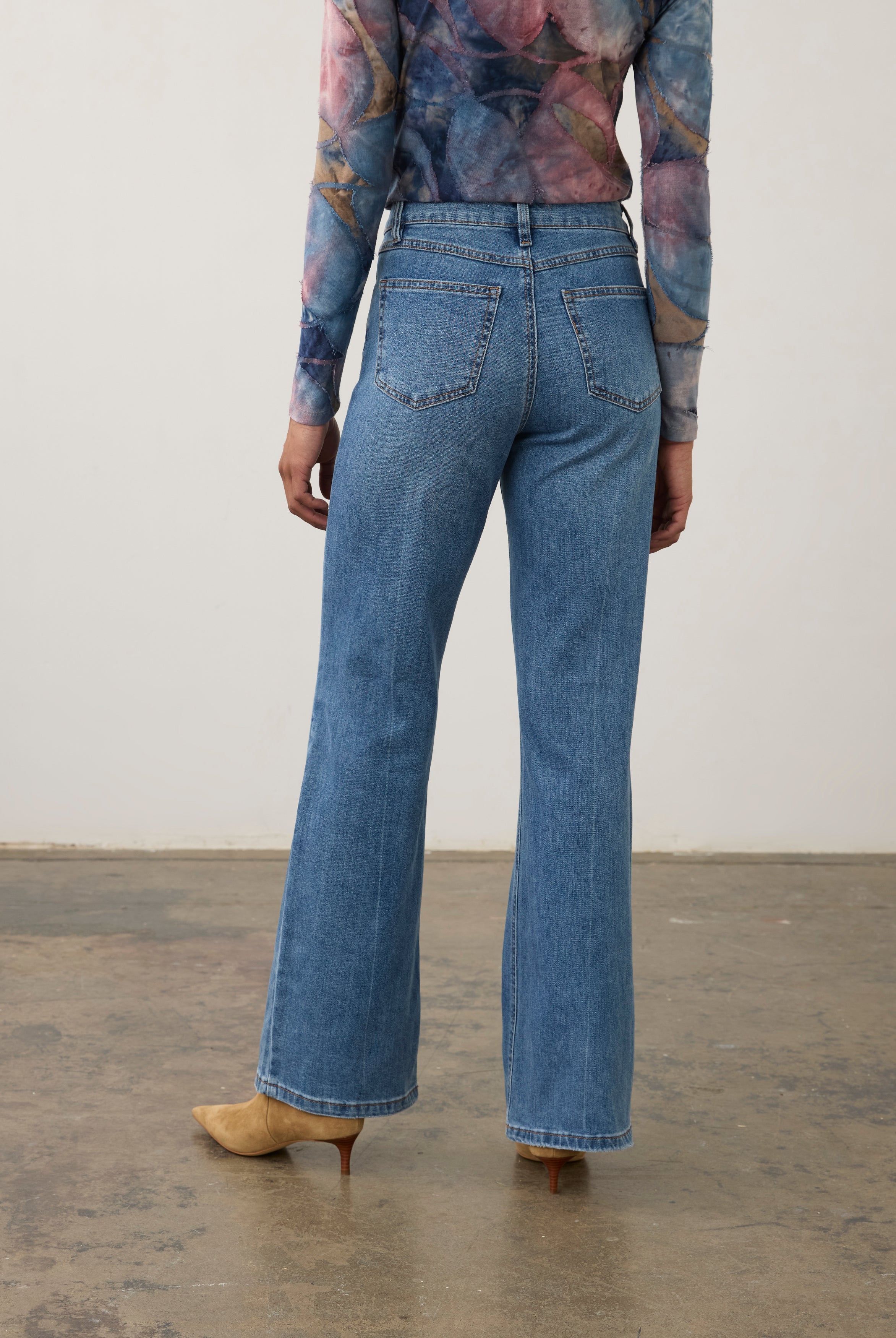 Back view of medium wash denim pants featuring back patch pockets and bootcut leg by French Dressing Jeans (FDJ) par French Dressing Jeans (FDJ)