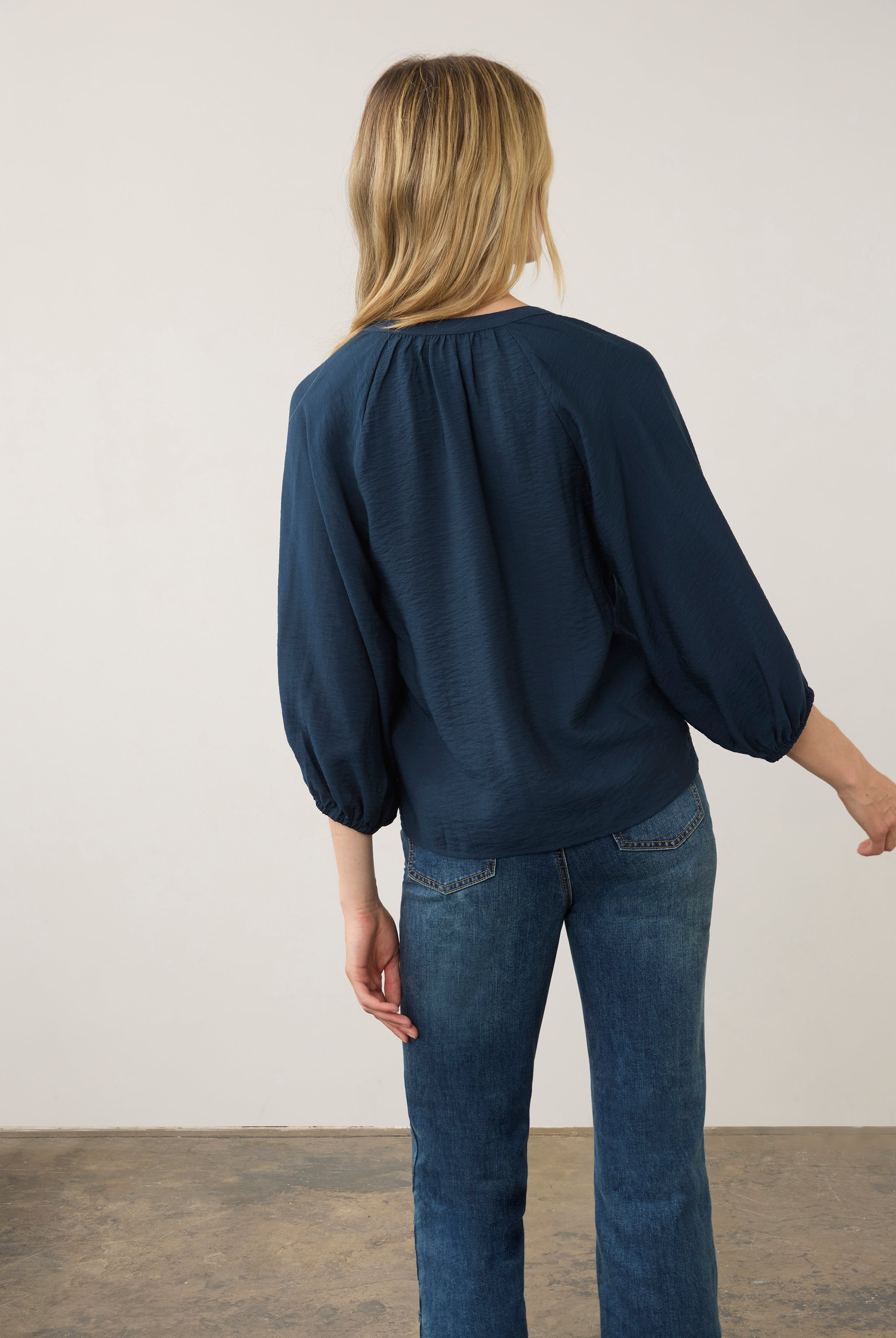 Back view of navy blouse showcasing puff sleeves by French Dressing Jeans (FDJ)