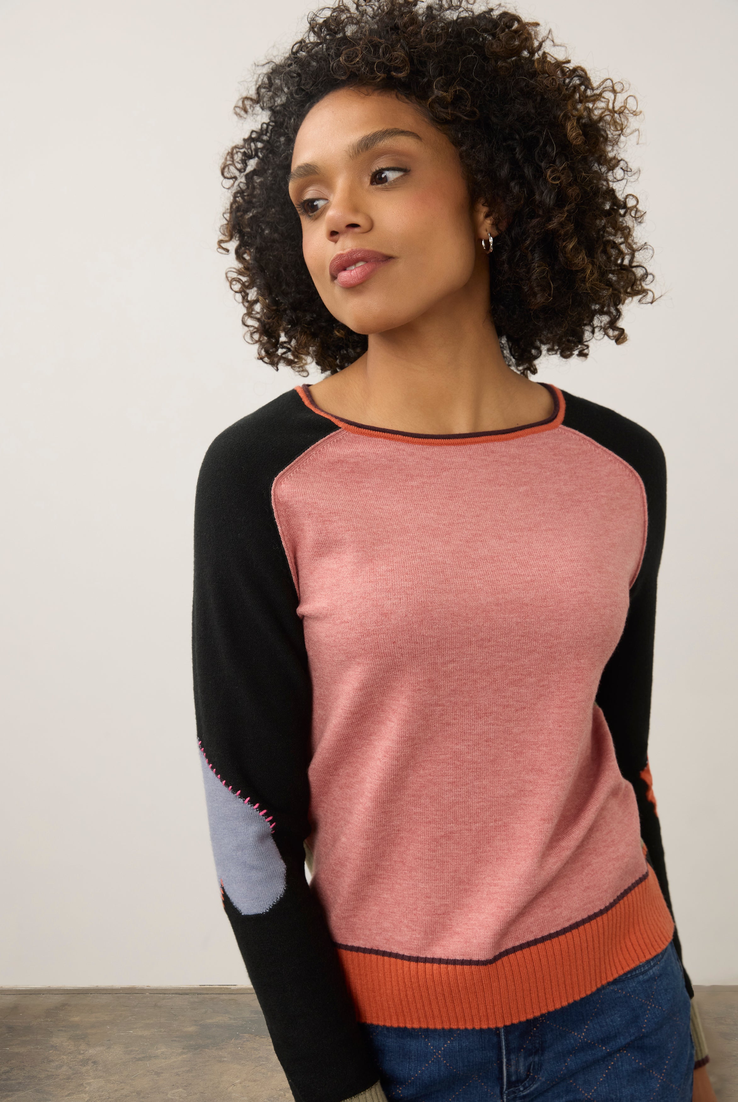 Close-up of pink and black colorblock sweater with contrasting sleeves by French Dressing Jeans (FDJ)