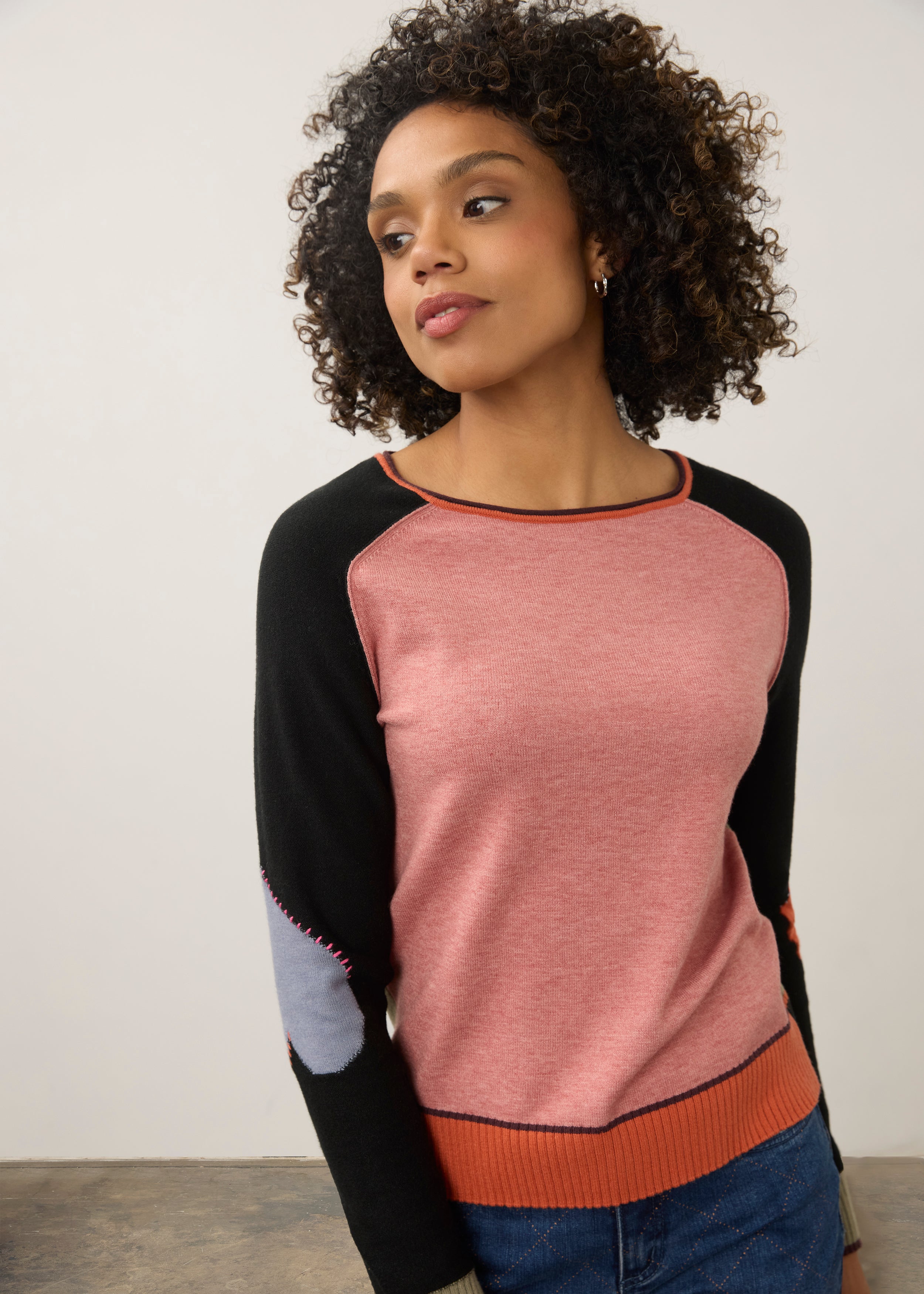 Close-up of pink and black colorblock sweater with contrasting sleeves by French Dressing Jeans (FDJ)