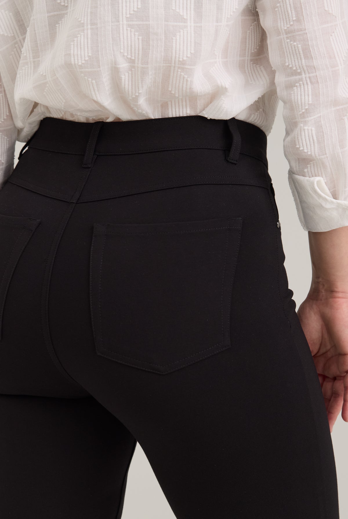 Close-up detail of black pants showing back patch pockets and stitching by French Dressing Jeans (FDJ)