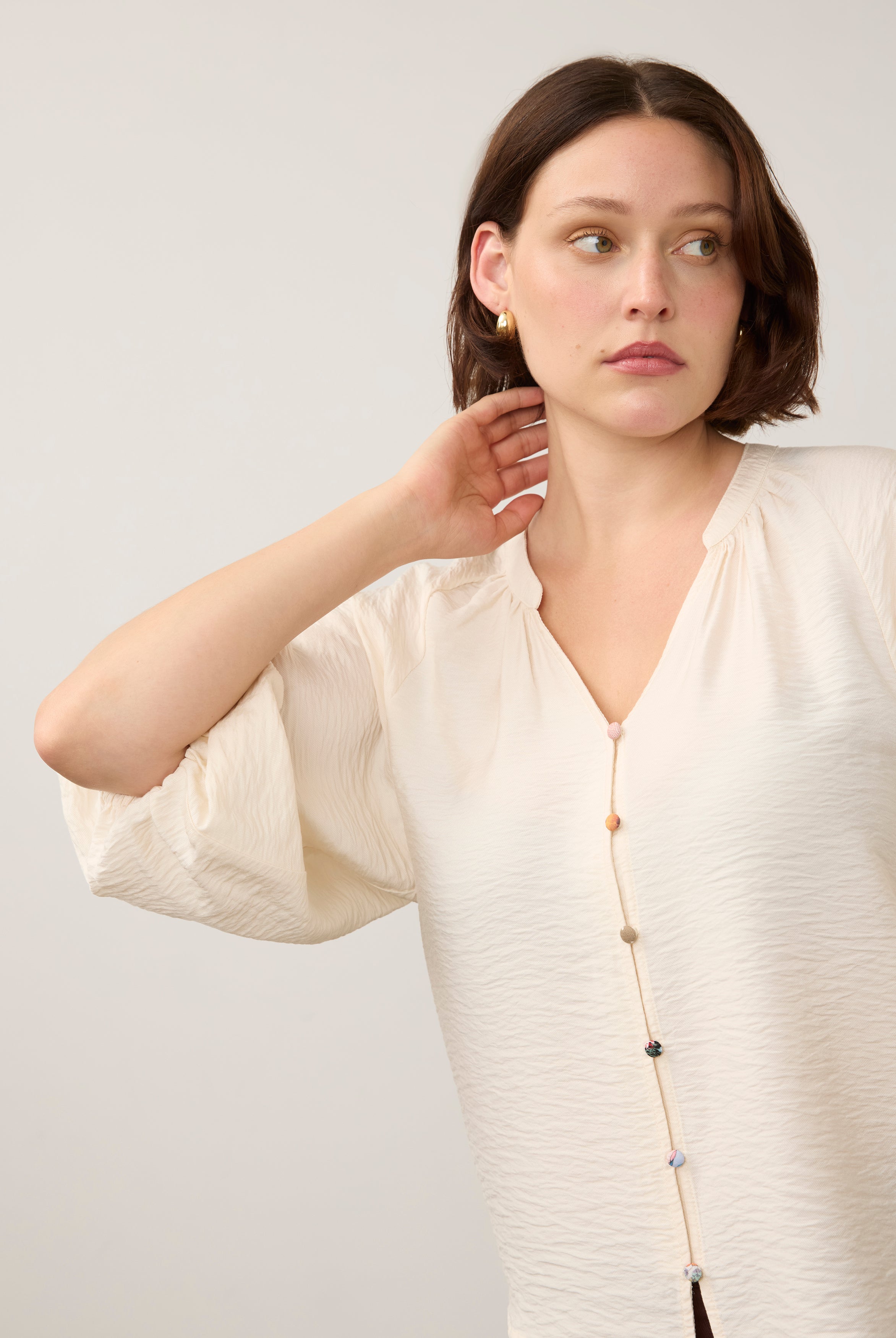Close-up of cream blouse emphasizing colorful buttons by French Dressing Jeans (FDJ)