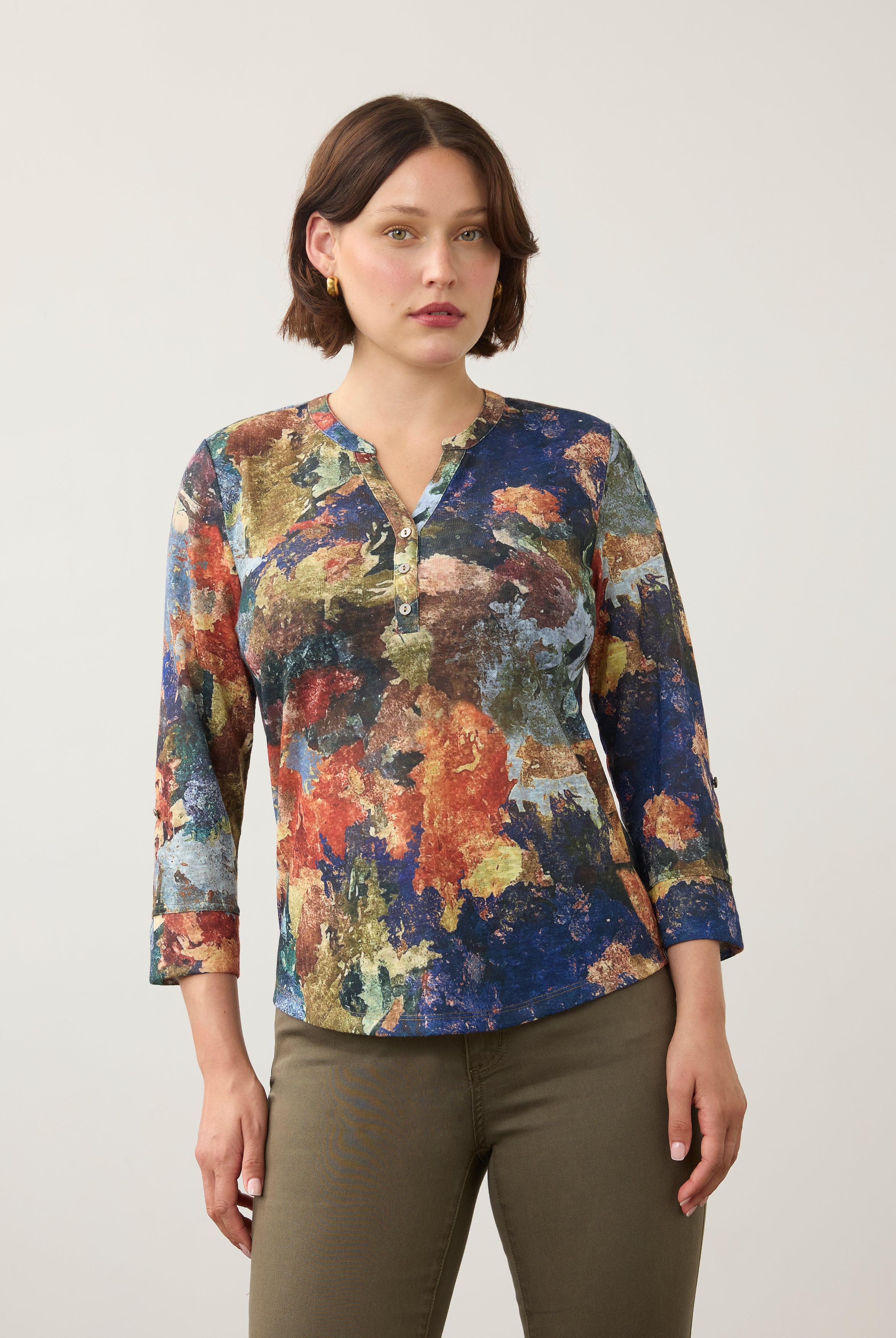 Front view of 3/4 sleeve Henley top in multicolor print, button-front, paired with olive pants by French Dressing Jeans (FDJ)