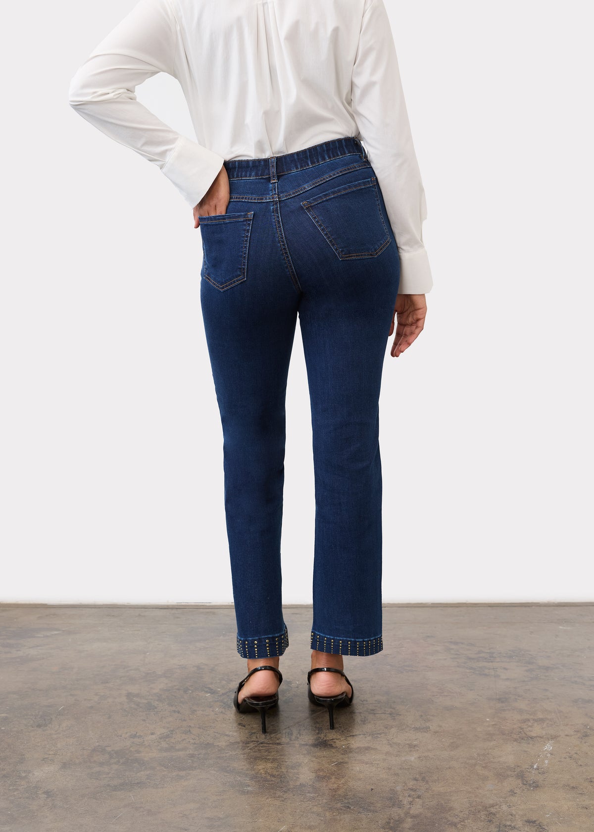 Back view of dark blue denim showing back patch pockets and mid-rise waist by French Dressing Jeans (FDJ)