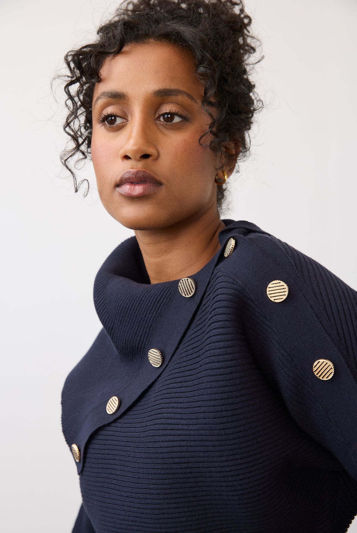 Close-up of navy sweater showing button accents on shoulder by French Dressing Jeans (FDJ)