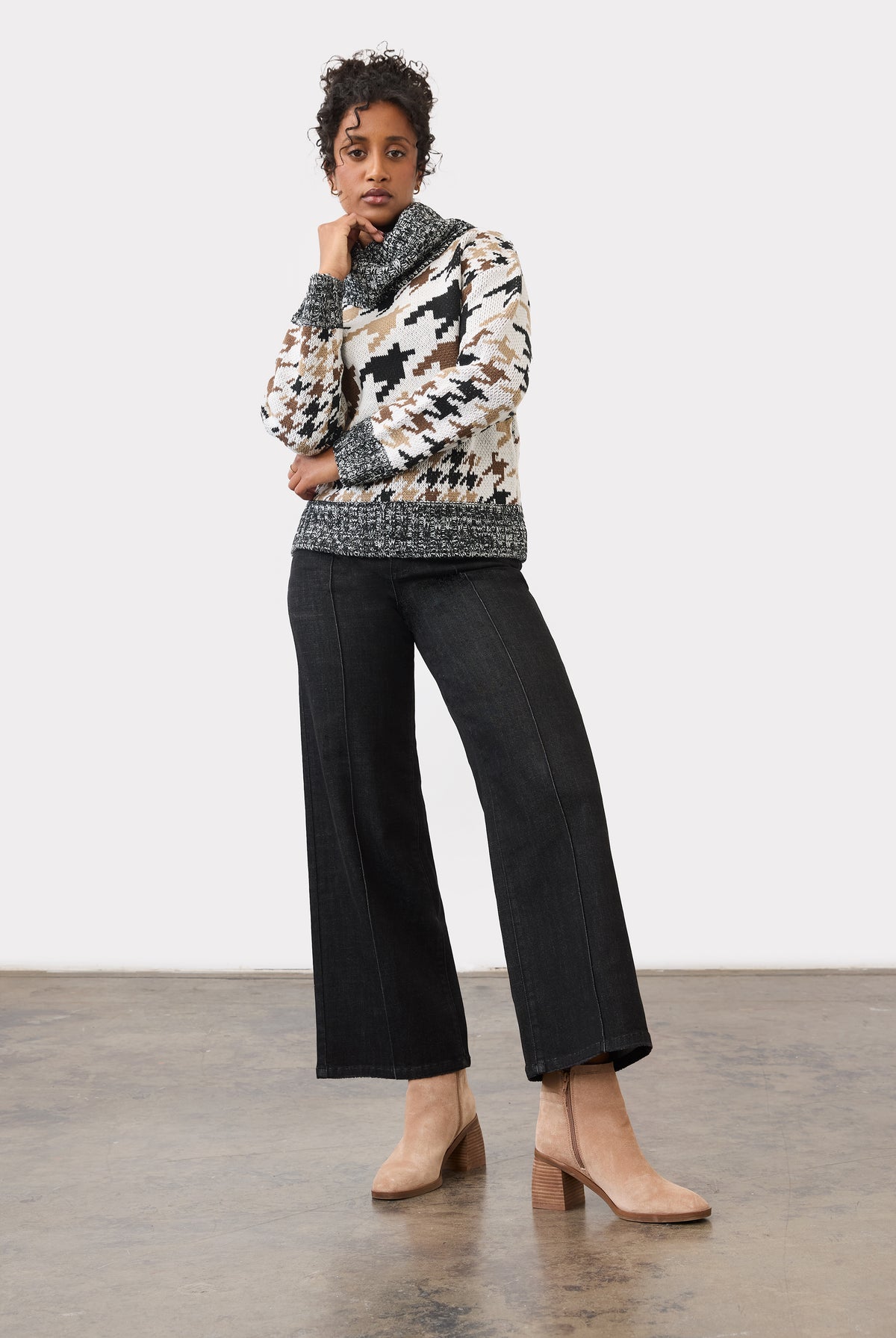 Full body view of black wide-leg jeans paired with patterned sweater by French Dressing Jeans (FDJ)
