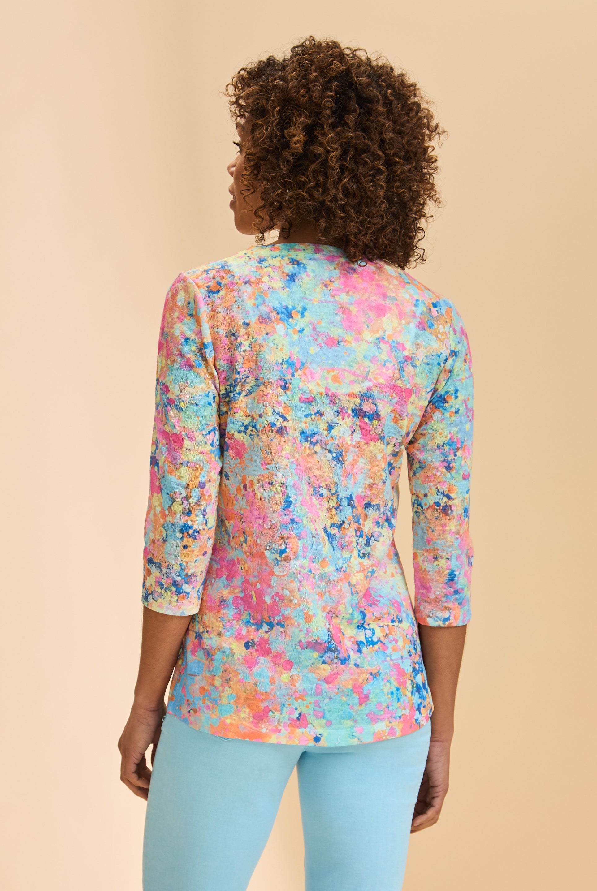 Back view showing 3/4 sleeves and vibrant abstract pattern on V-neck top by French Dressing Jeans (FDJ)