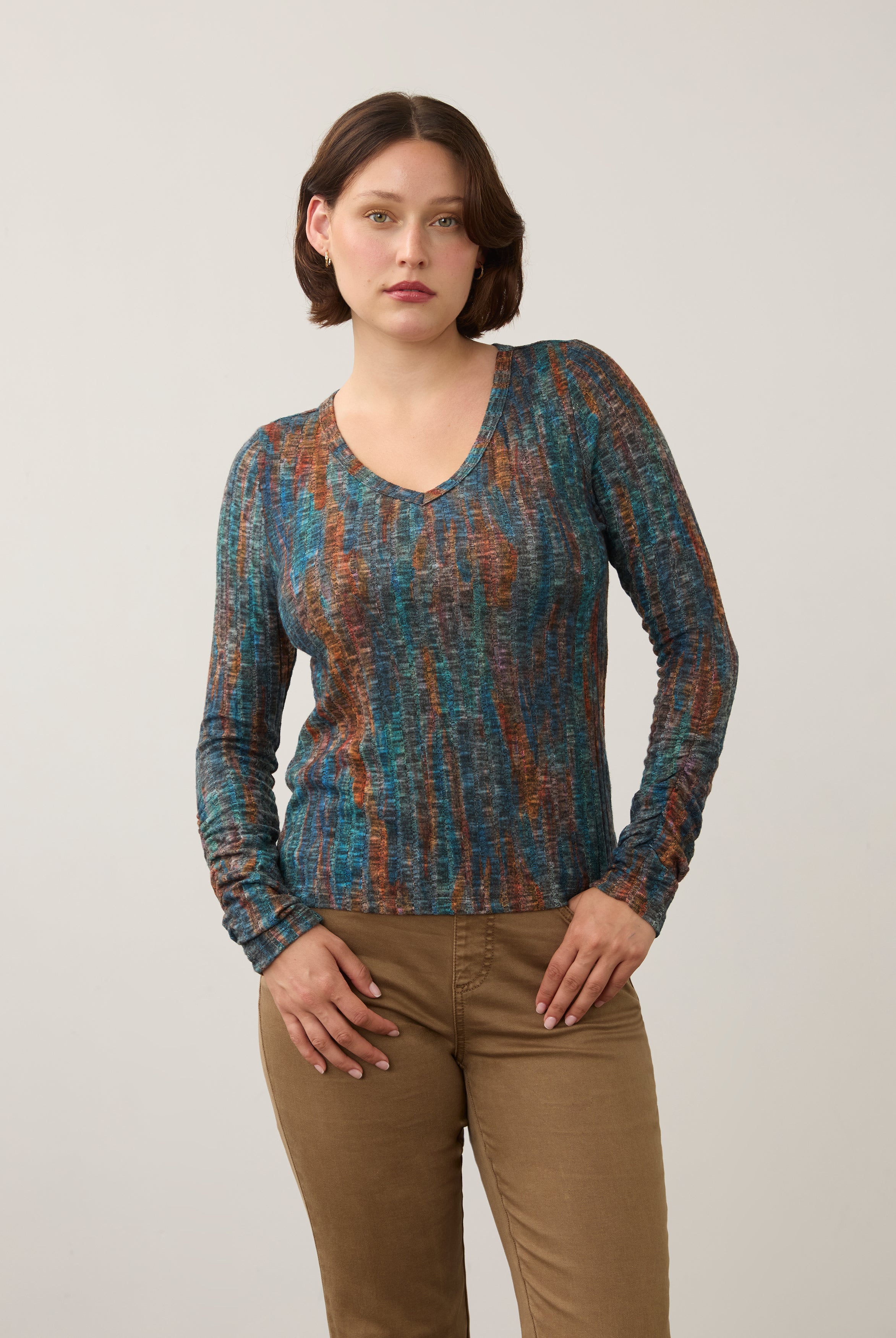 Front view of striped V-neck top in earthy tones, paired with beige pants by French Dressing Jeans (FDJ)