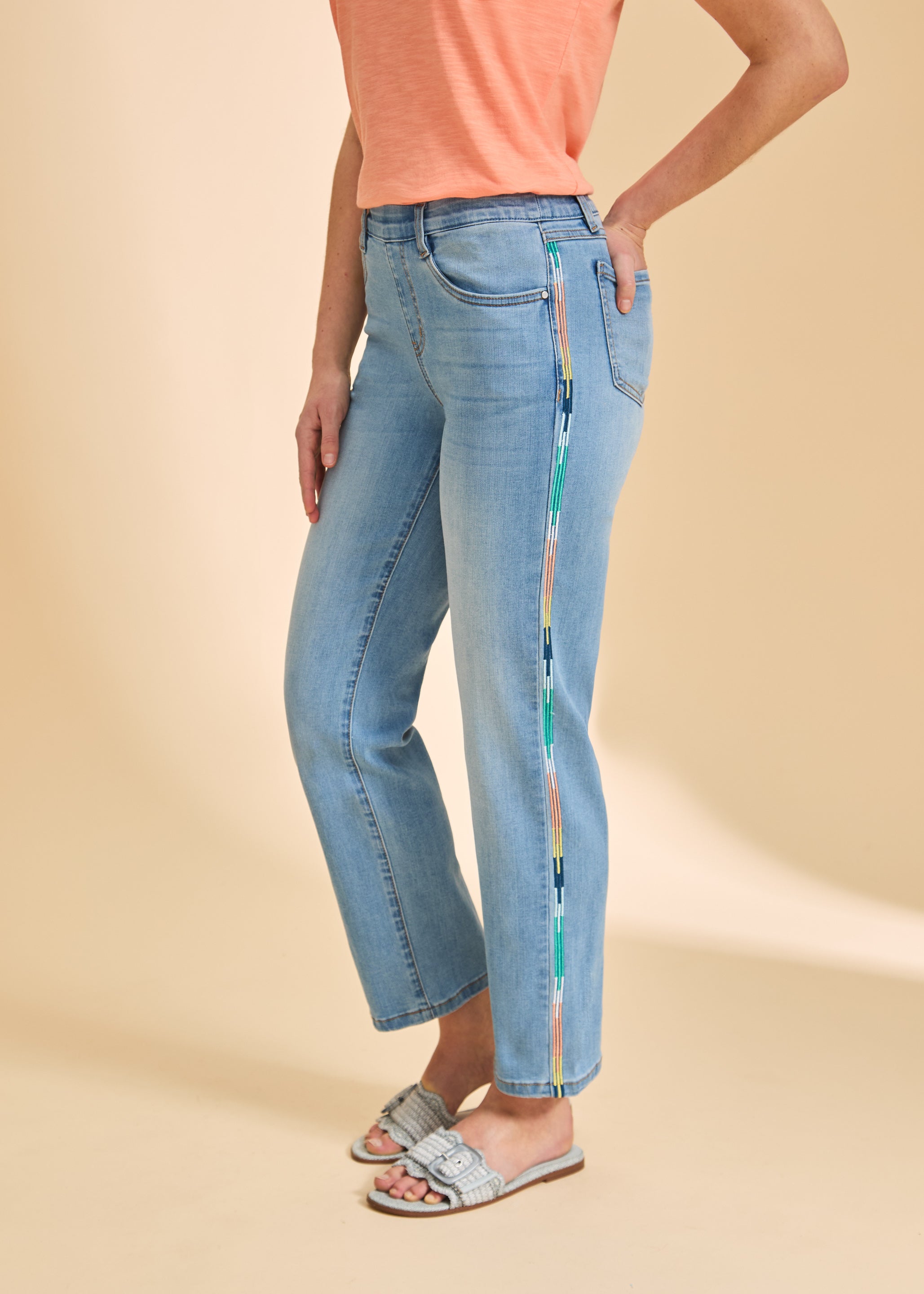 Close-up side view of medium blue ankle jeans highlighting colorful stripe detail by French Dressing Jeans (FDJ)