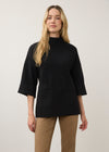 Front view of black tunic sweater with wide sleeves and front pockets by French Dressing Jeans (FDJ)