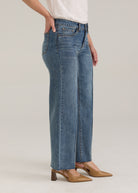 Side profile of Olivia denim in light wash highlighting wide ankle and mid-rise waist by French Dressing Jeans (FDJ)