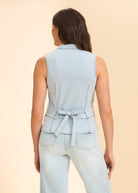 Back view of sleeveless denim top with tie detail and light wash jeans by French Dressing Jeans (FDJ)