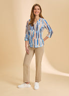 Full body view of blue stripe Henley top with beige pants and casual sneakers by French Dressing Jeans (FDJ)