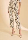 Close-up of beige plumeria crop pants highlighting floral pattern and high-rise waist by French Dressing Jeans (FDJ)
