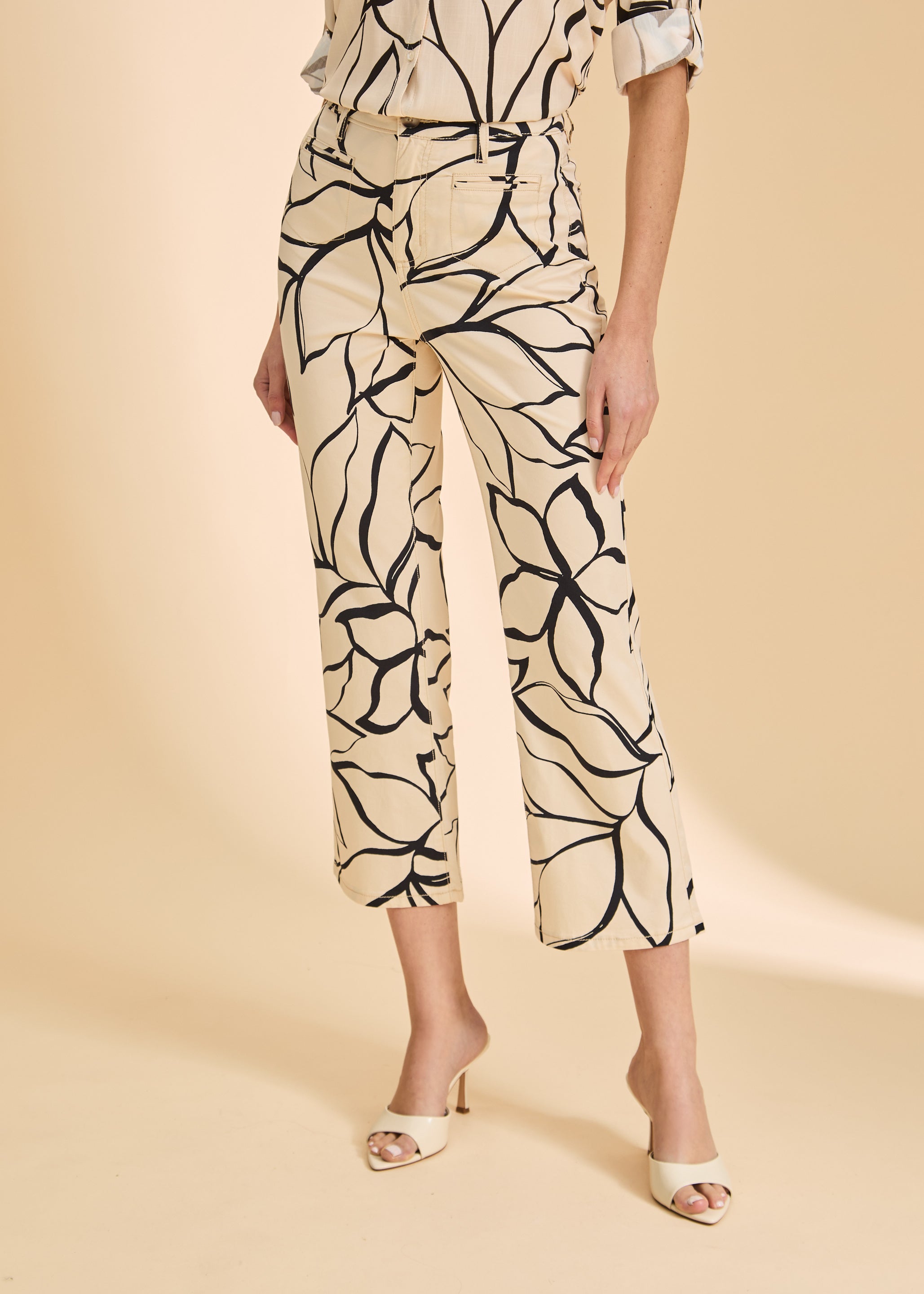 Close-up of beige plumeria crop pants highlighting floral pattern and high-rise waist by French Dressing Jeans (FDJ)