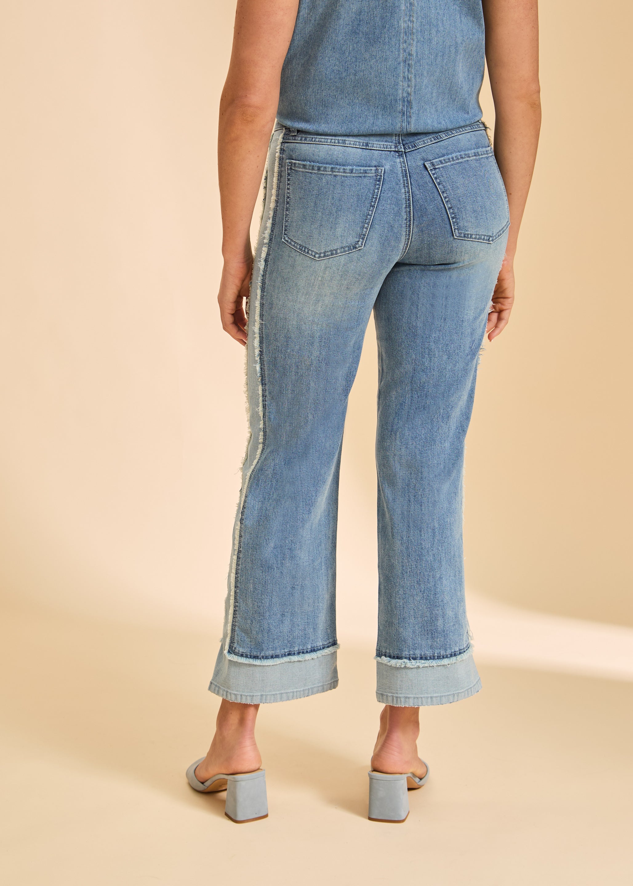 Back view of Olivia wide ankle denim in light wash showing back patch pockets and frayed side seams by French Dressing Jeans (FDJ)