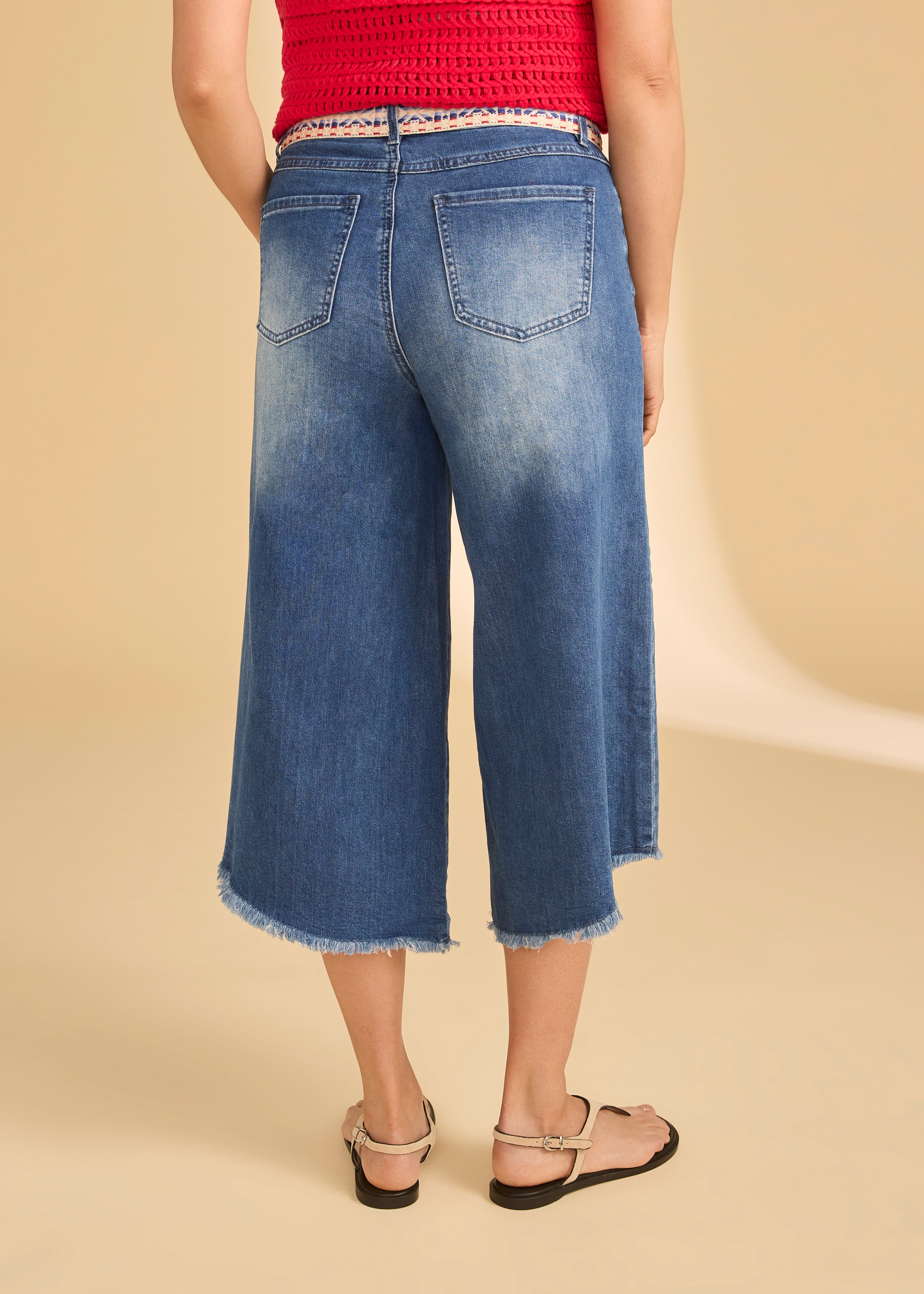 Back view of denim culottes showcasing patch pockets and raw hem by French Dressing Jeans (FDJ)
