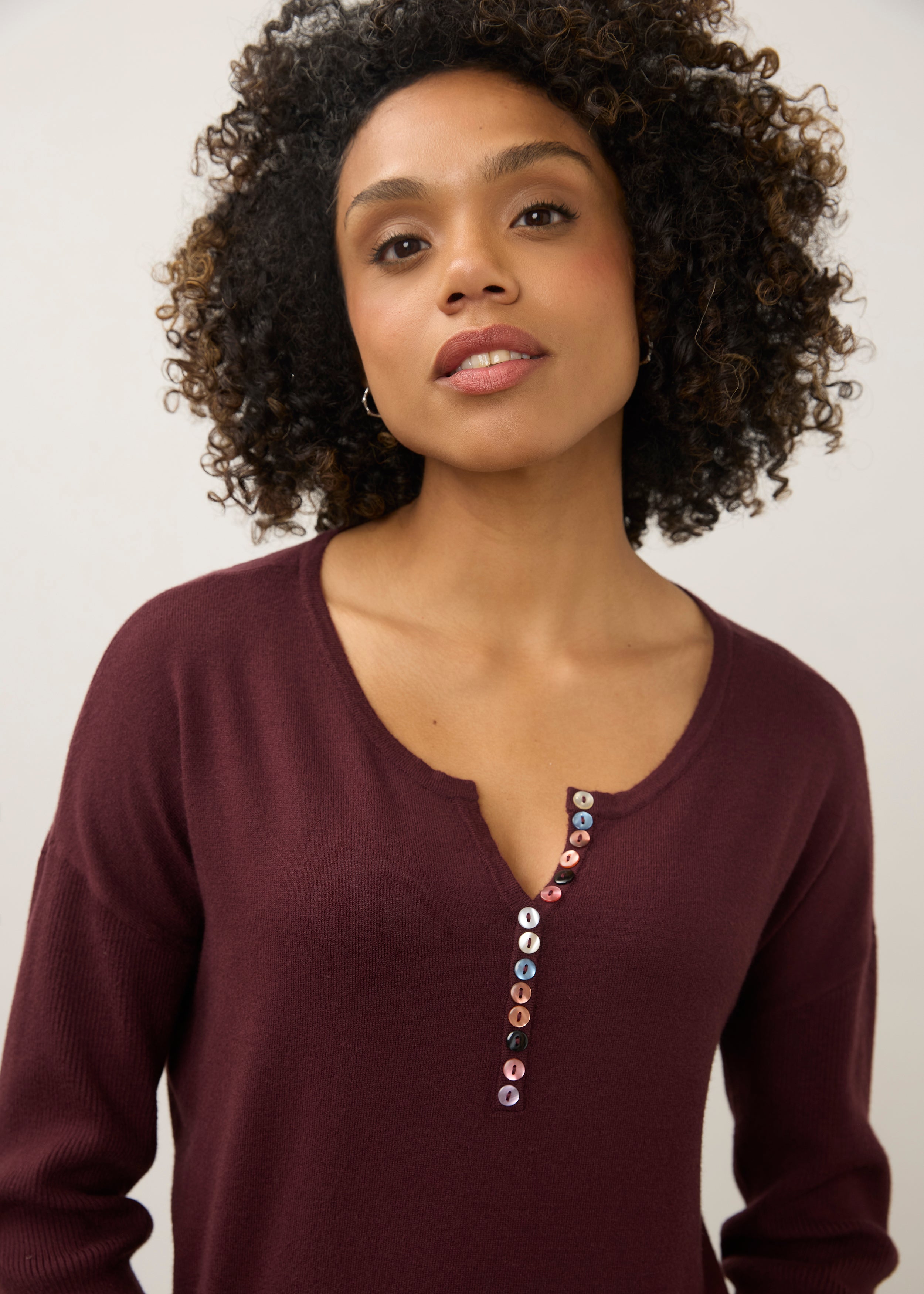 Close-up of burgundy sweater focusing on button accents by French Dressing Jeans (FDJ)