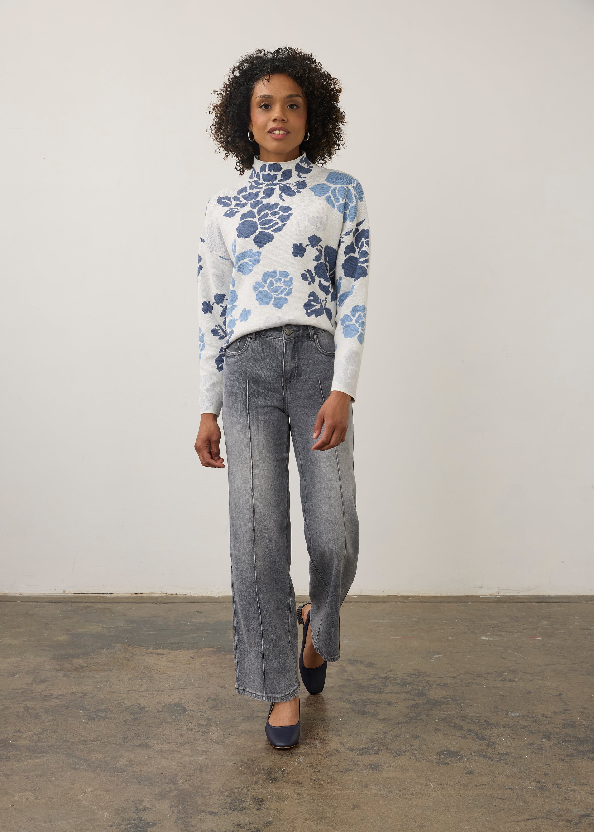 Model in blue floral sweater with grey jeans, full outfit view by French Dressing Jeans (FDJ)