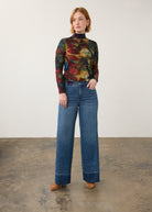 Full body view of wide-leg dark wash jeans with artistic top, showcasing relaxed fit by French Dressing Jeans (FDJ) par French Dressing Jeans (FDJ)