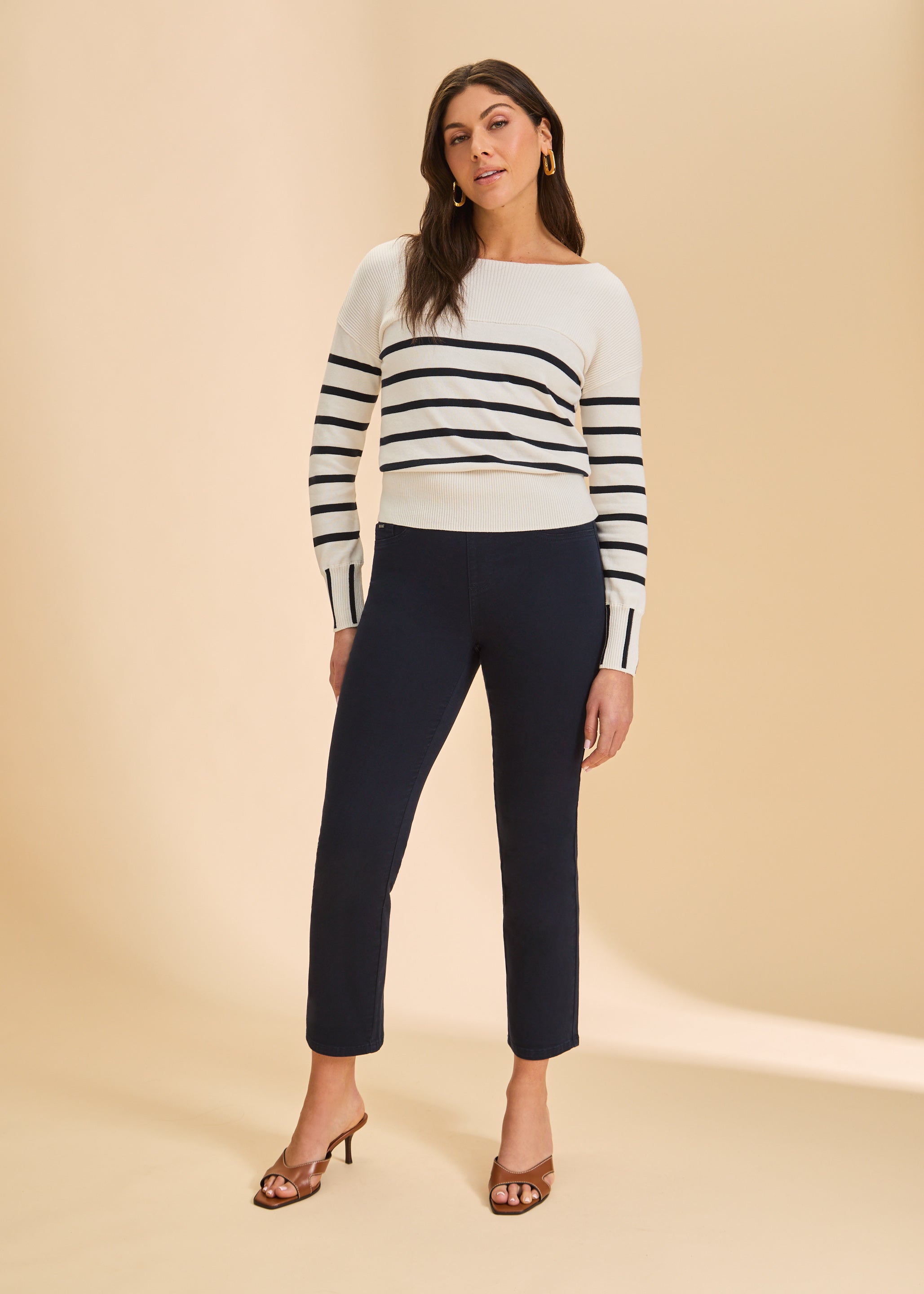 Full view of white/black stripe sweater paired with dark pants by French Dressing Jeans (FDJ)