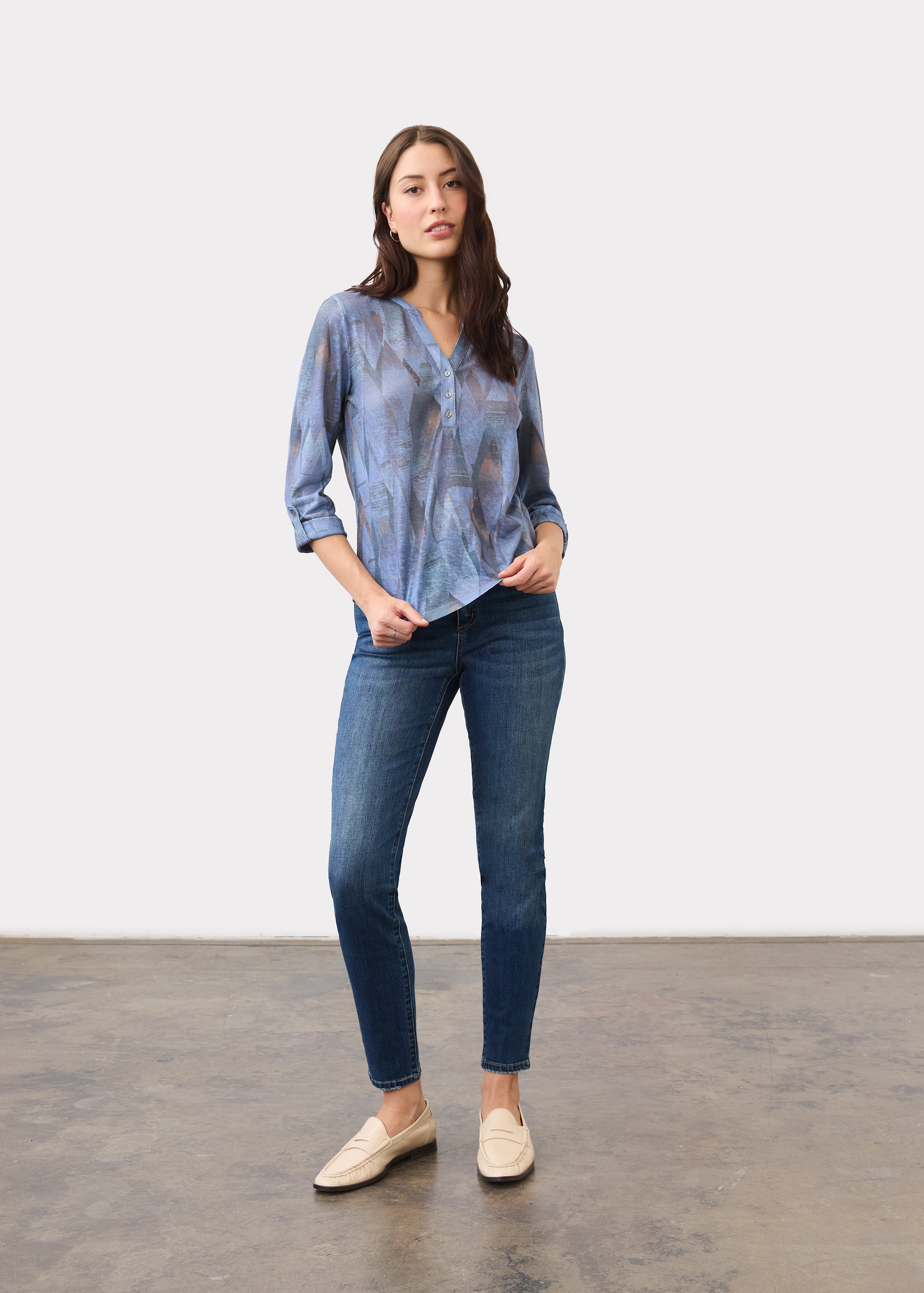 Full body view of indigo Henley top with 3/4 sleeves paired with jeans by French Dressing Jeans (FDJ)
