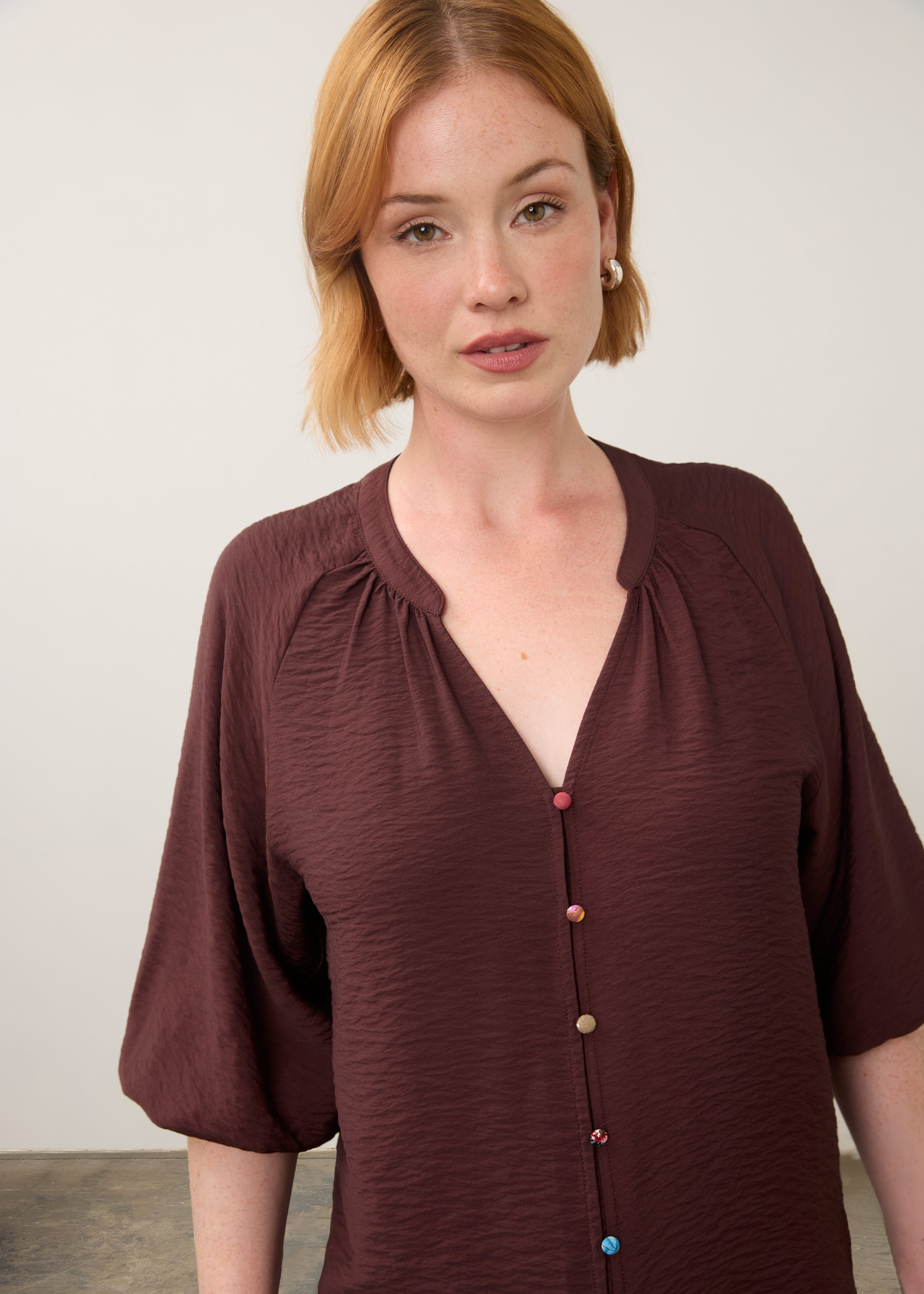 Close-up of maroon blouse focusing on colorful buttons by French Dressing Jeans (FDJ)