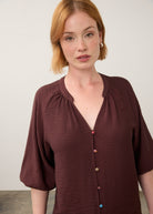 Close-up of maroon blouse focusing on colorful buttons by French Dressing Jeans (FDJ)