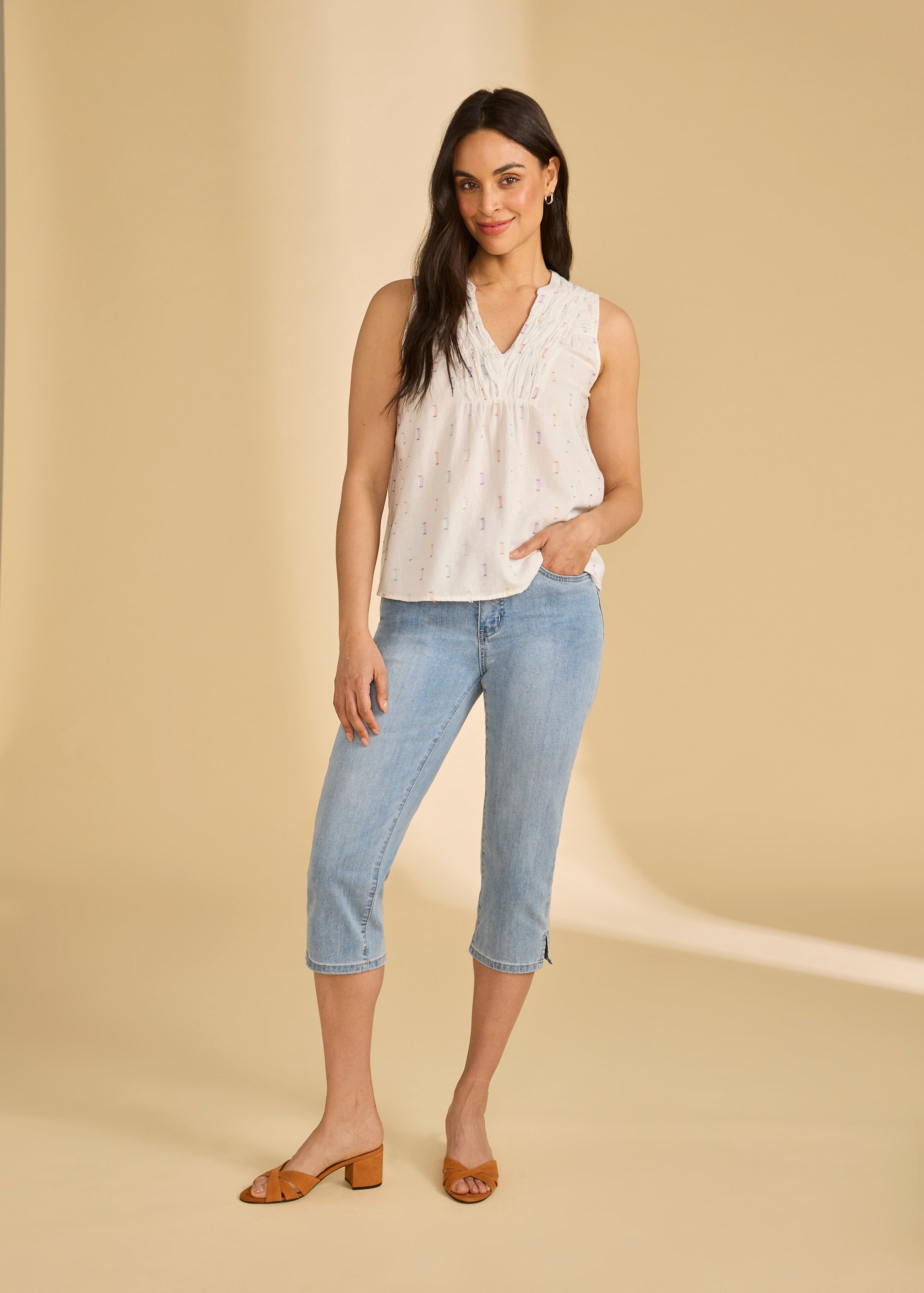 Full view of white sparkle sleeveless blouse paired with jeans, showing relaxed fit, by French Dressing Jeans (FDJ)