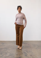 Full body view of argyle patterned sweater with black pants by French Dressing Jeans (FDJ)
