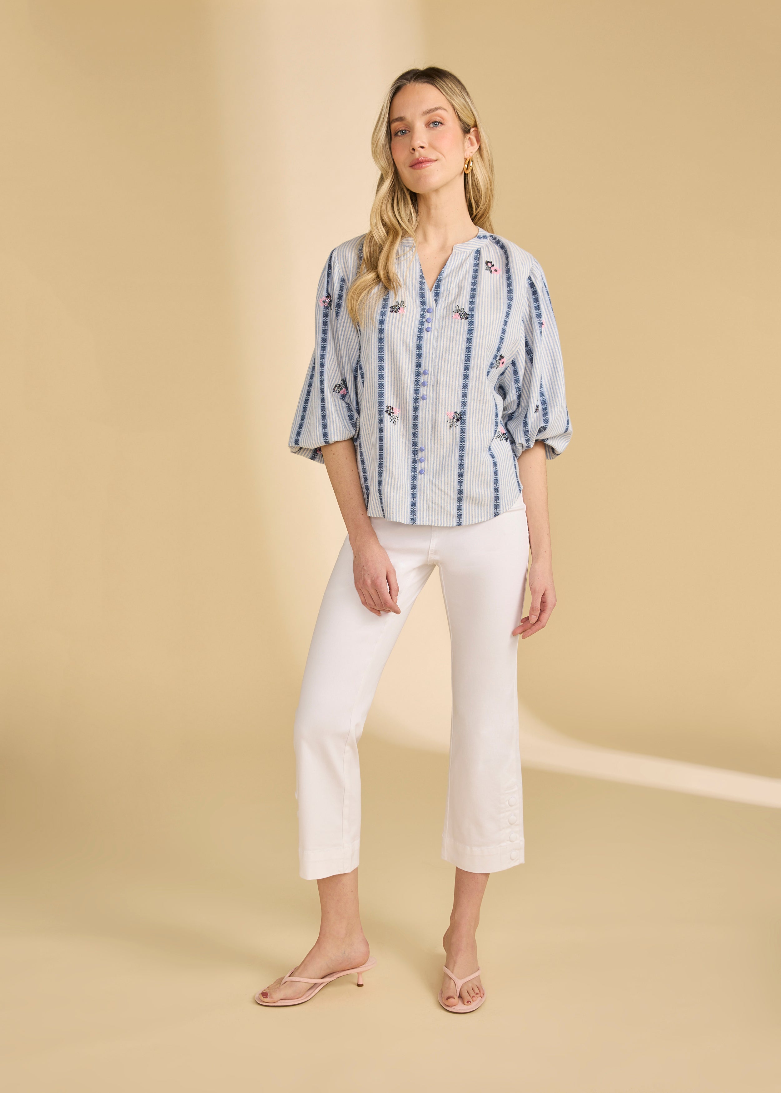 Full view of striped shirt with floral accents paired with white cropped pants by French Dressing Jeans (FDJ)